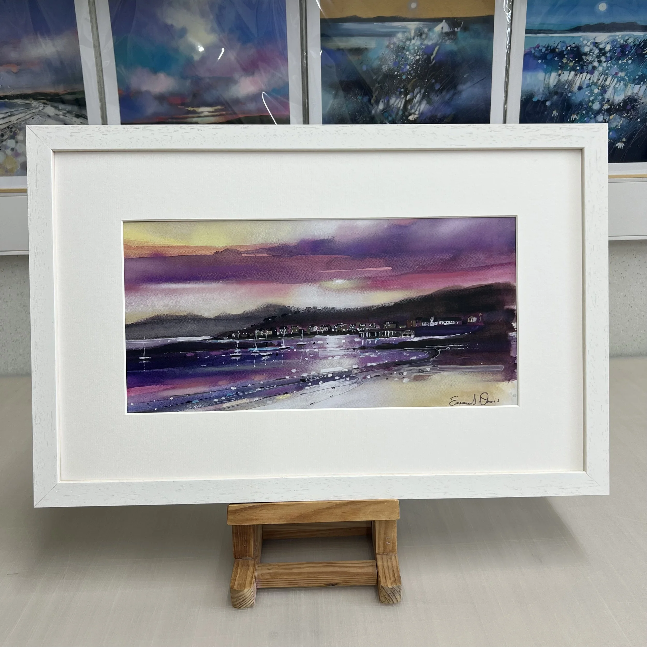 The view from Millport beach looking towards West Bay and Arran beyond on the Isle of Cumbrae, Scotland depicted beautifully in Emma S Davis Artist's open edition framed art print.