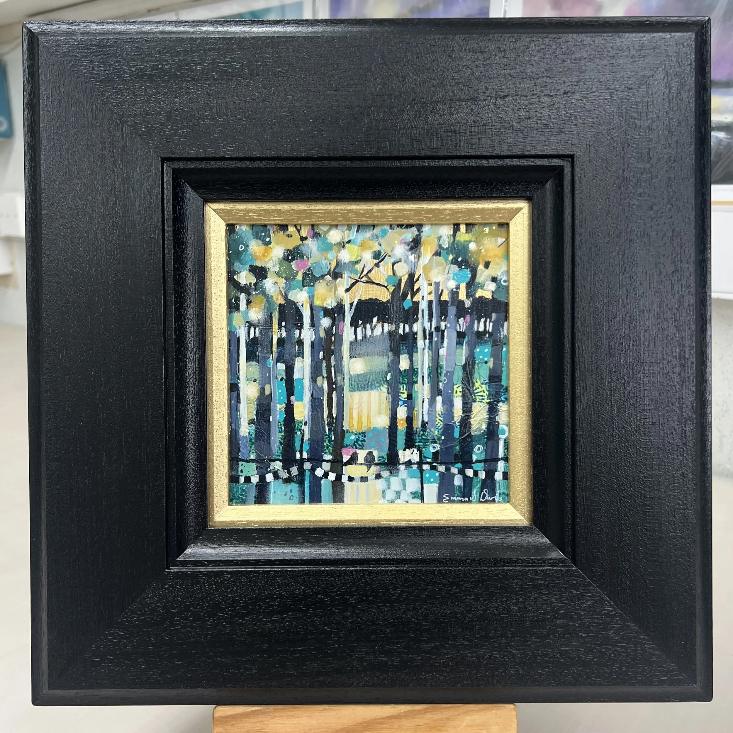 Original oil painting of a Scottish landscape glowing with warm golden evening light by Scottish artist Emma S Davis. Framed view.