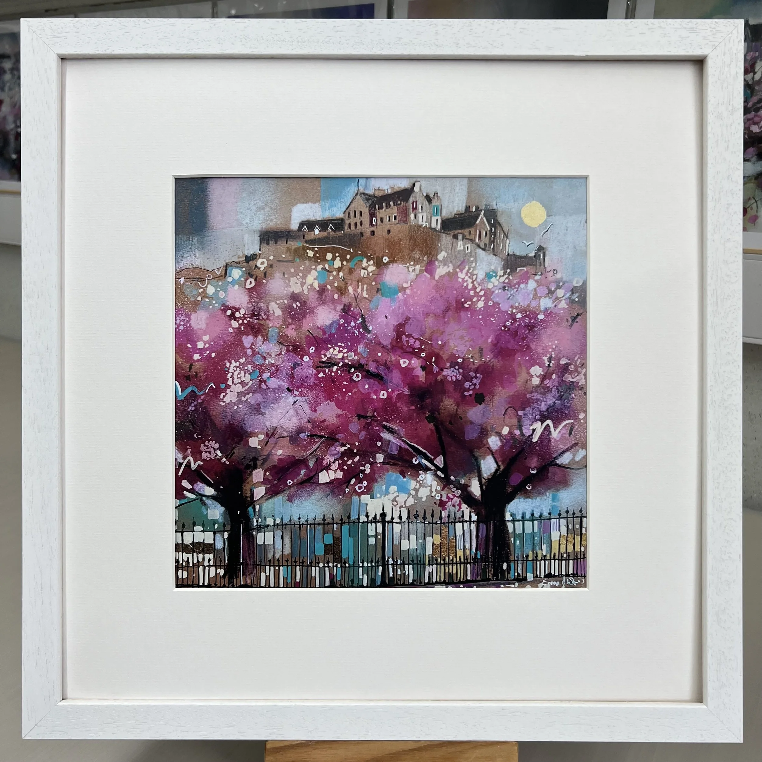 Edinburgh in Bloom artwork featuring Edinburgh Castle above blossom trees in Princes Street Gardens, Scotland. Framed in white option.