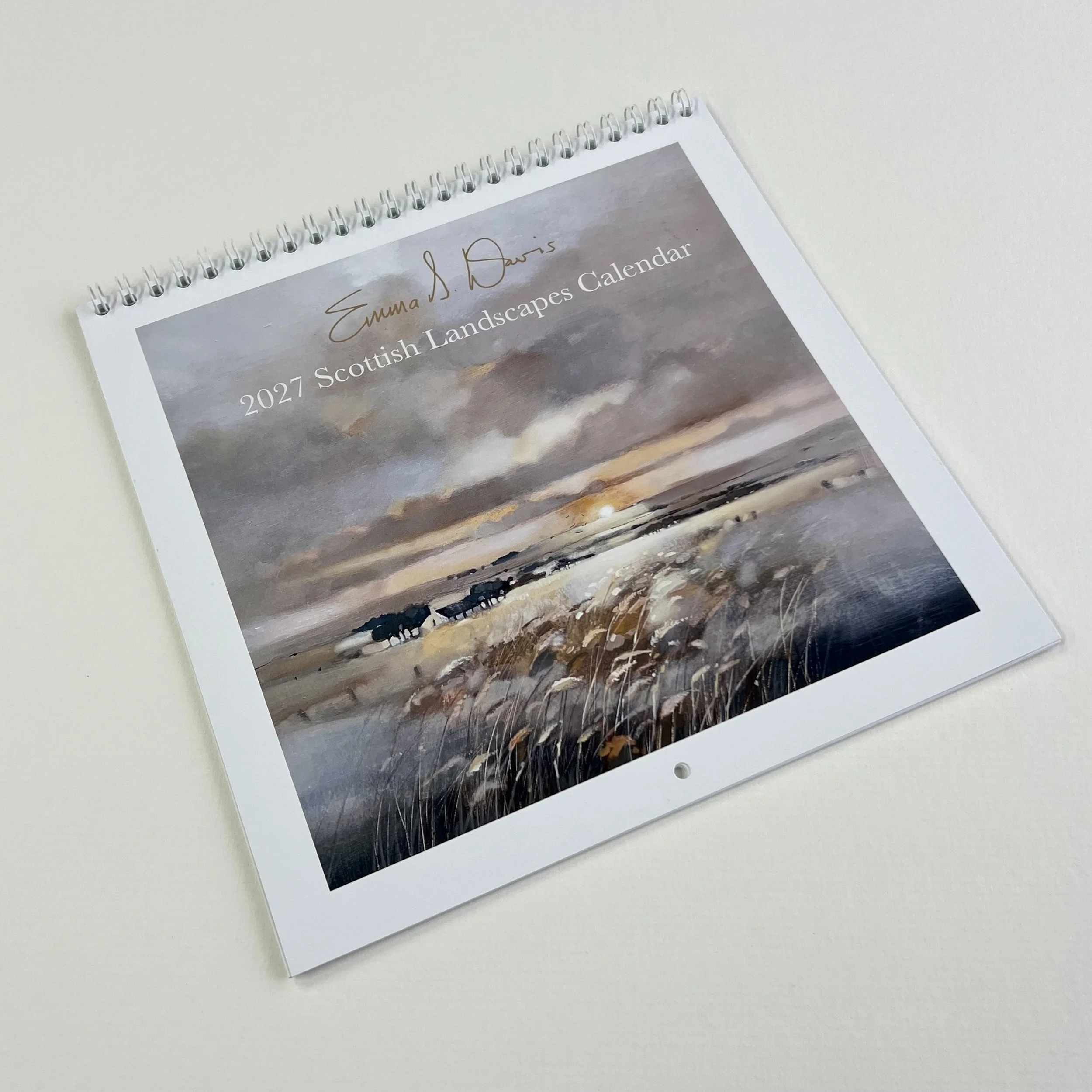 Emma S Davis 2027 Scottish Landscapes Calendar front cover featuring a Scottish countryside painting with a golden sunset.