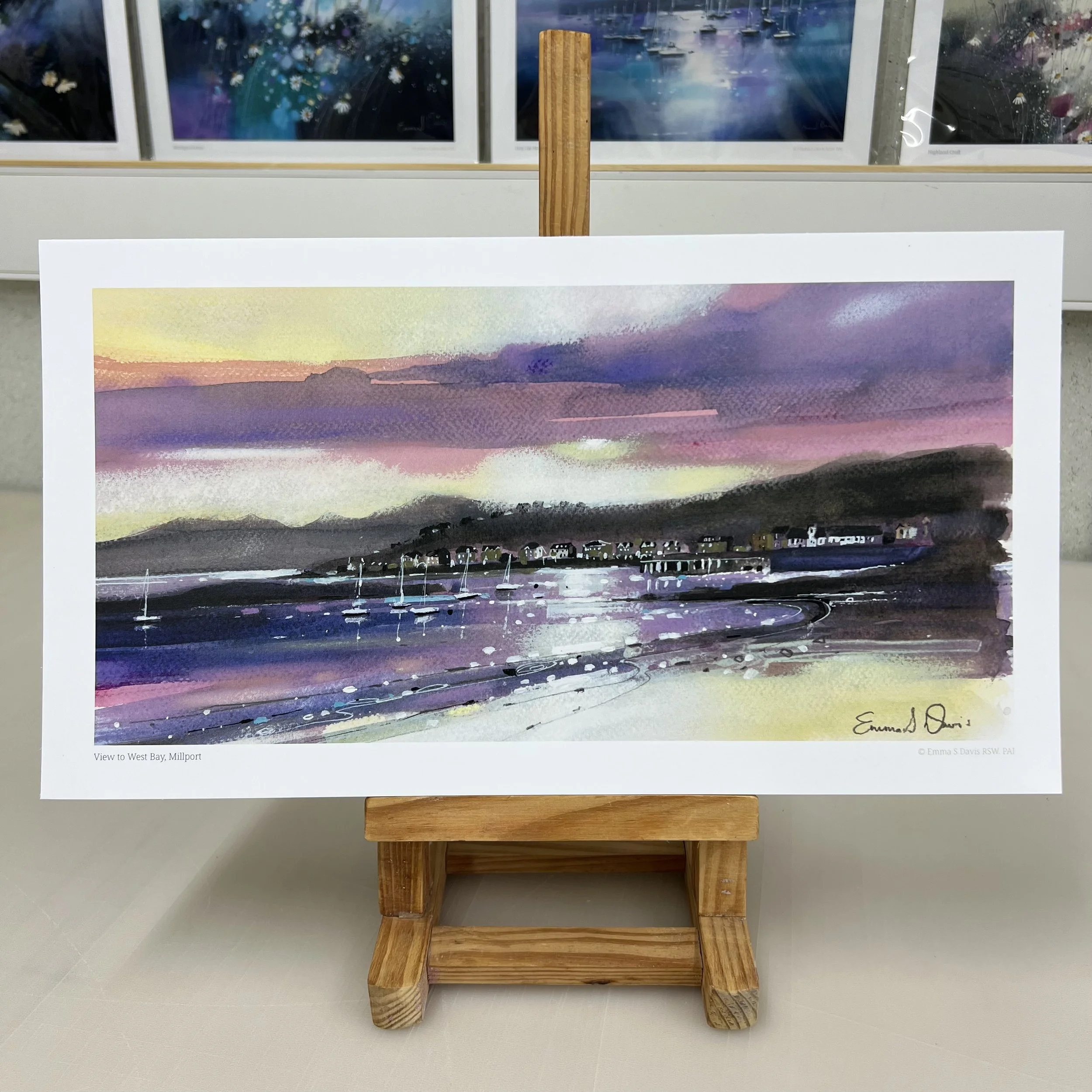 Millport beach looking towards West Bay and Arran beyond on the Isle of Cumbrae, Scotland depicted beautifully in Emma S Davis Artist's open edition art print.