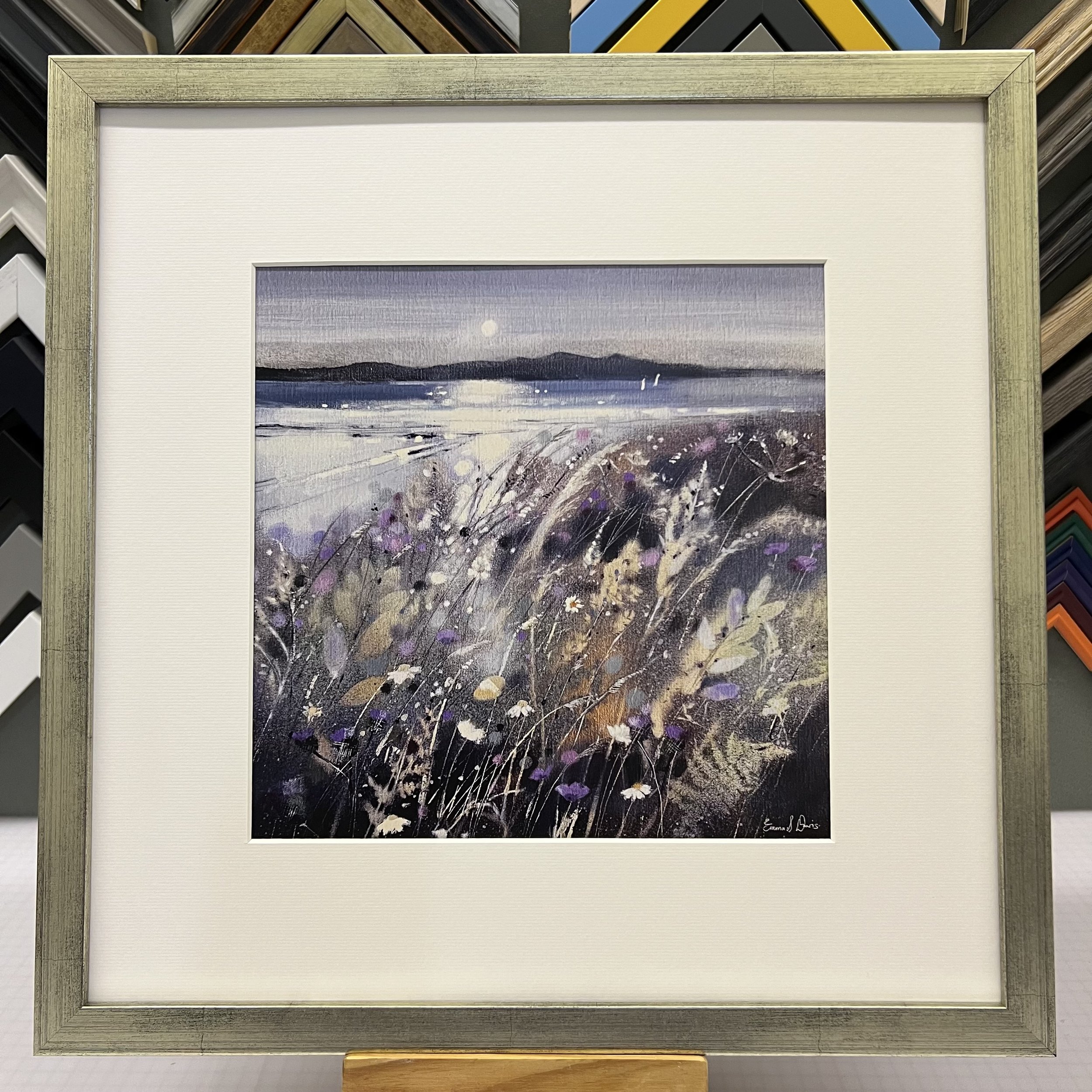 Summer Fields and Arran Open Edition Art Print by Emma S Davis. Presented in a silver frame, showcasing Arran on the horizon and wildflowers dancing in the summer breeze.