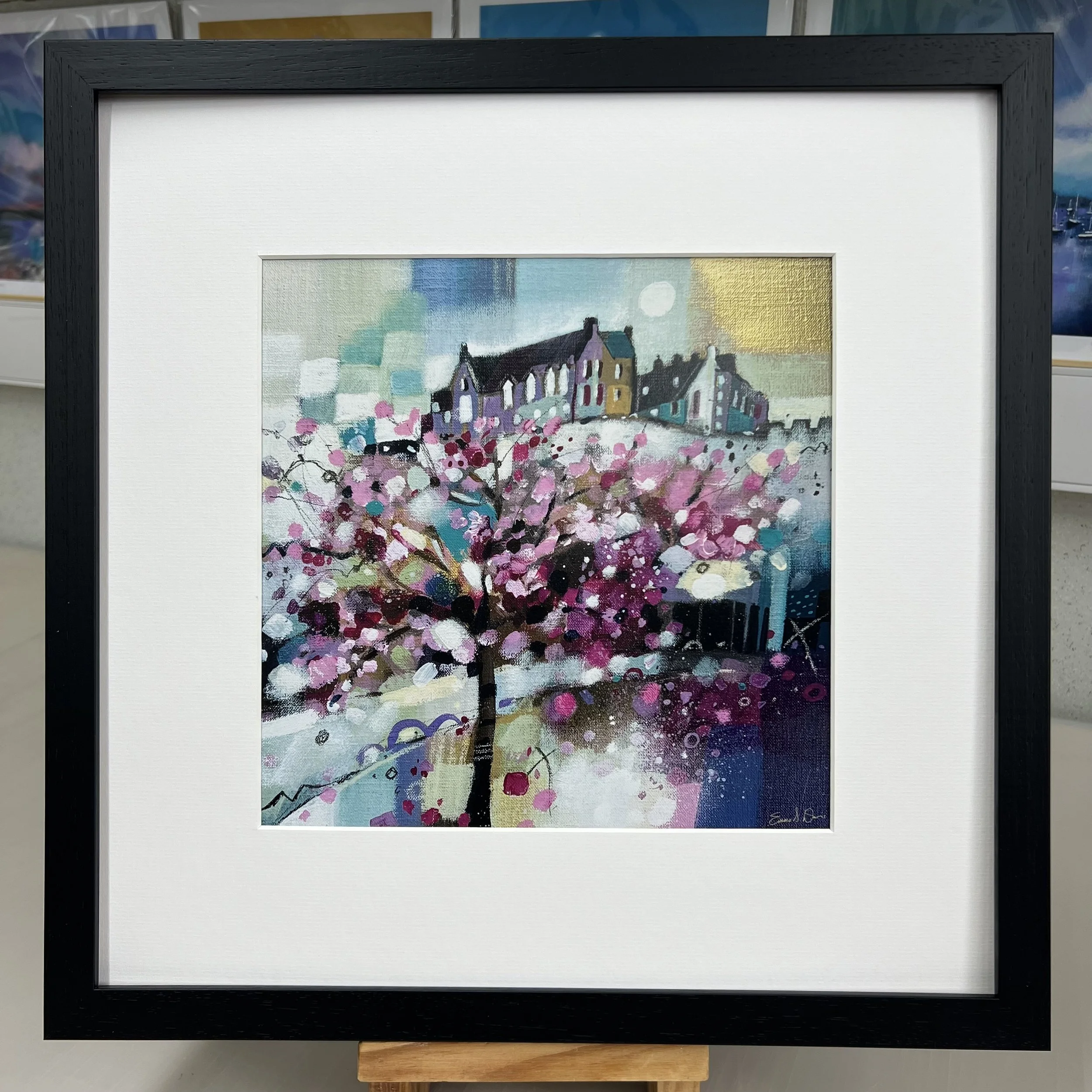 Blossom trees in Princes Street Gardens below Edinburgh Castle come to life in Emma S Davis Artist's open edition art print with black frame.