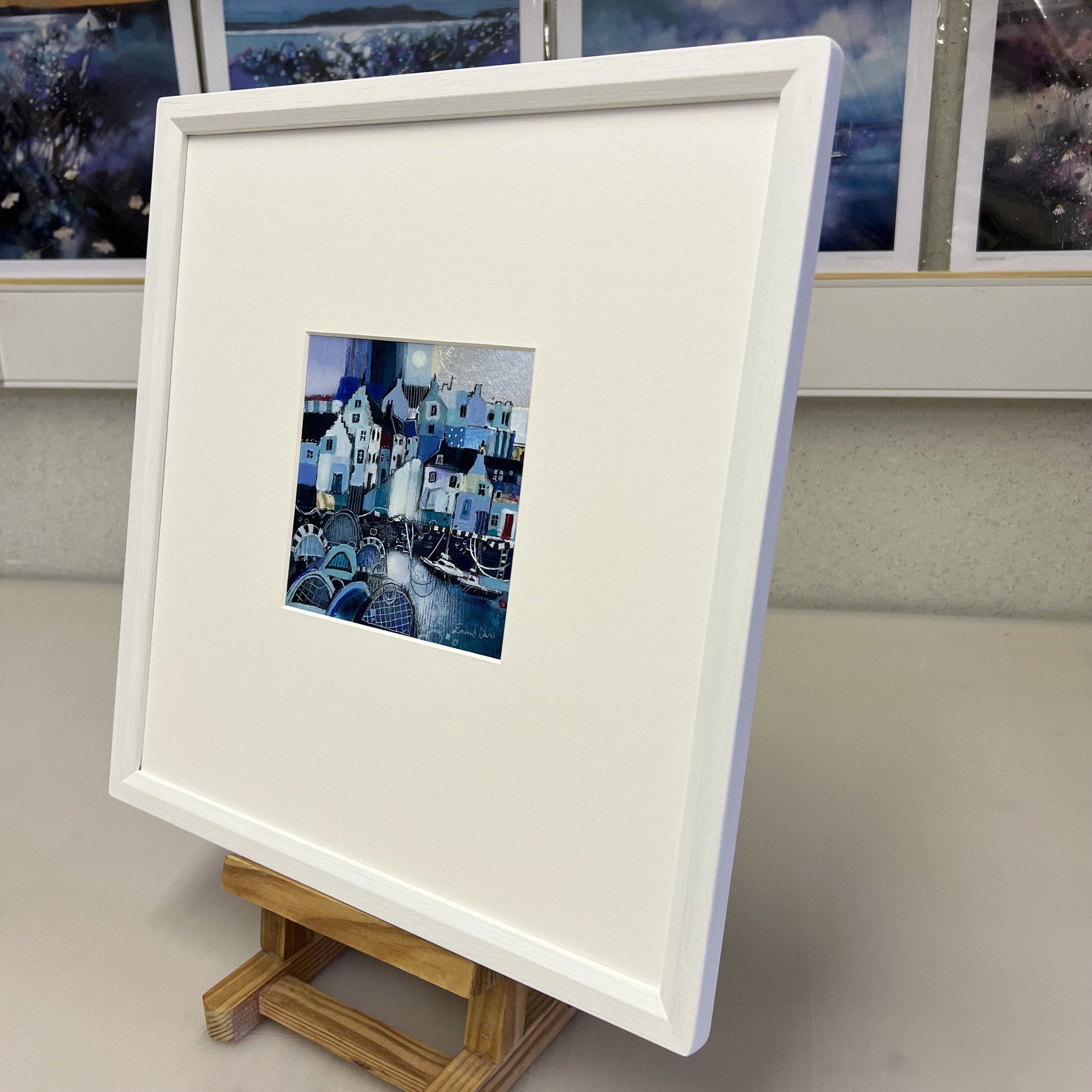 Alternate side view of framed painting of East Neuk of Fife's traditional fishing village harbour of Crail caught in time by Emma S Davis Artist's 'Moonlight Shimmers, Crail' original painting.