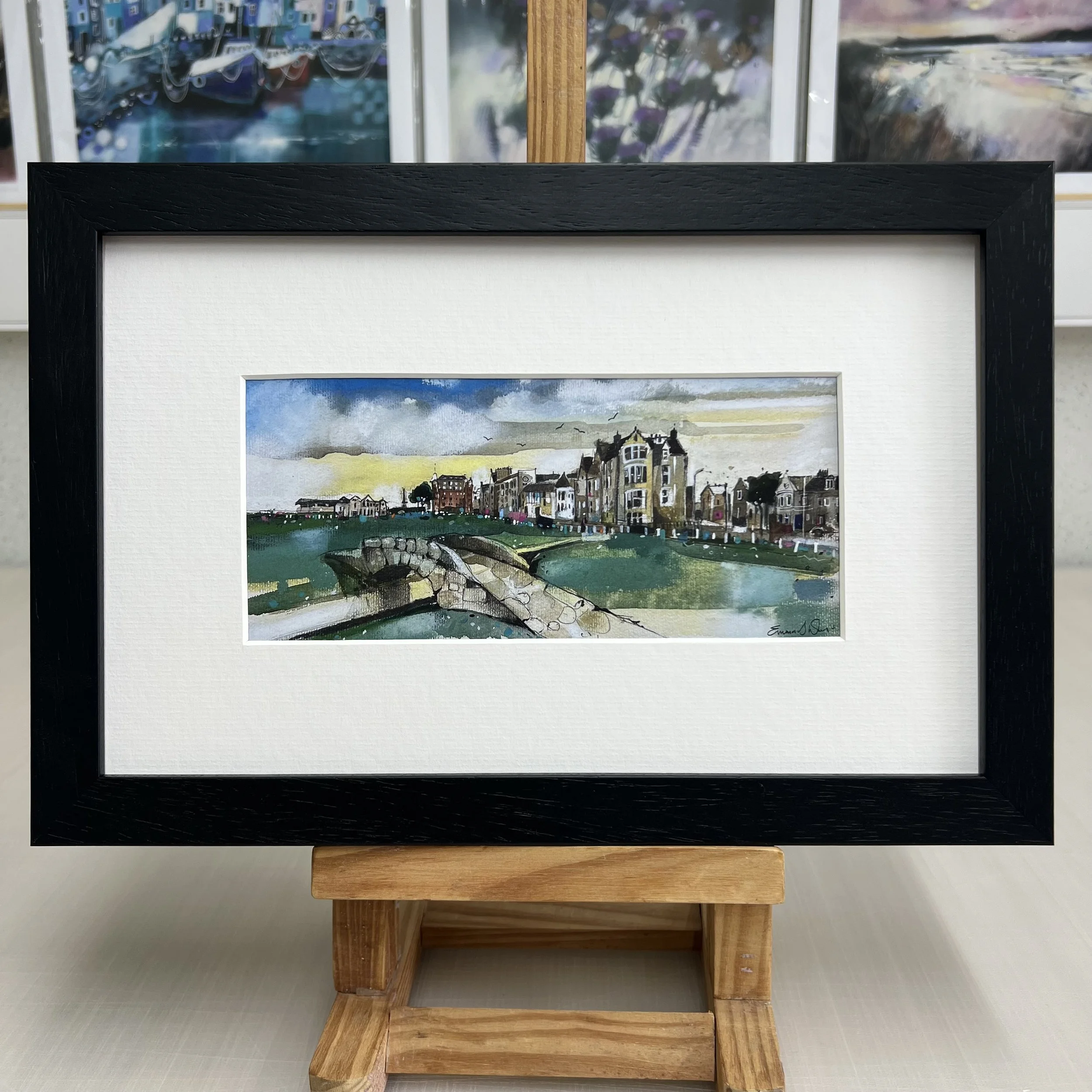 Framed Swilcan Bridge St Andrews artwork showing Old Course 18th green and clubhouse. Black frame.