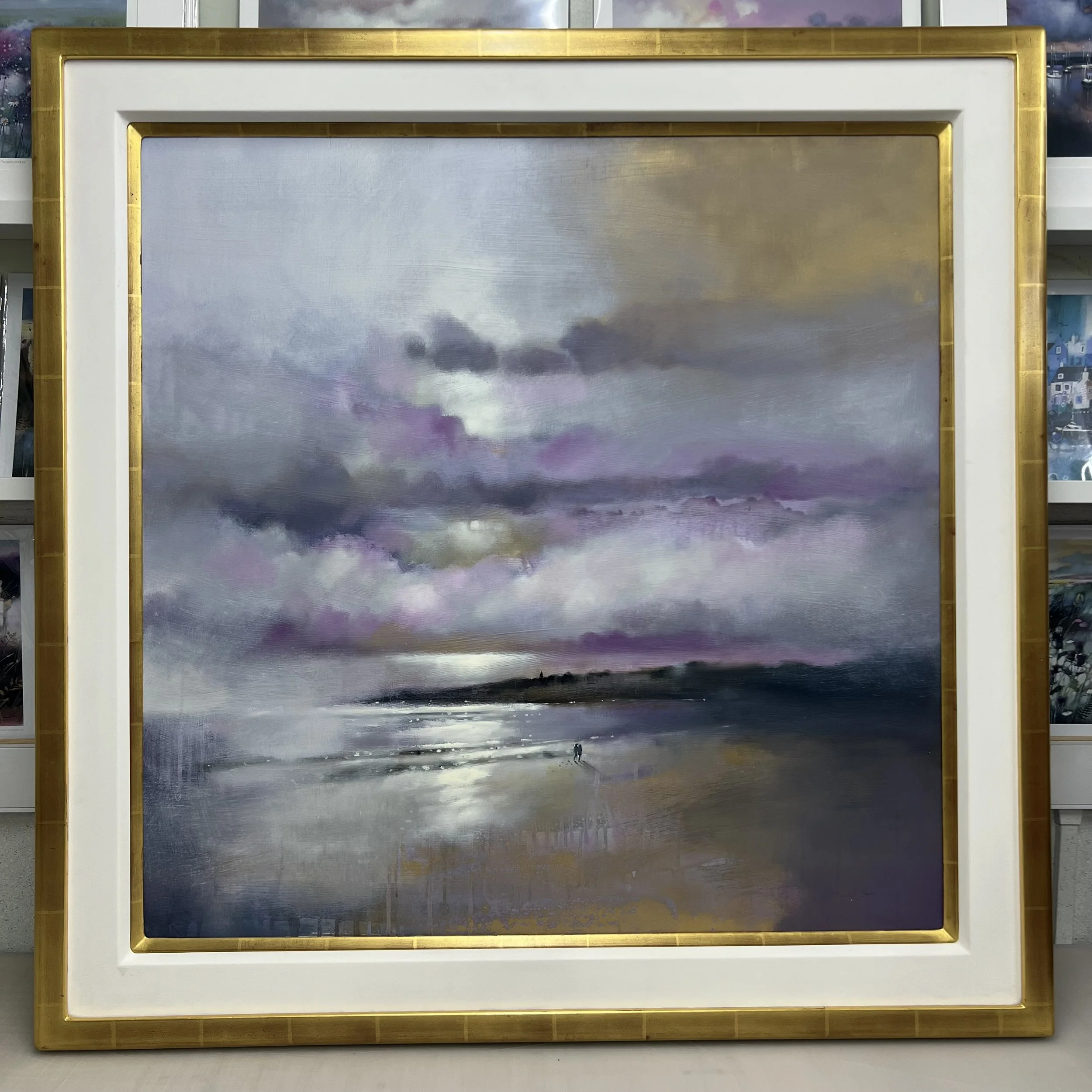 Together, St Andrews by Emma S Davis original oil painting featuring two figures walking along the shoreline beneath dramatic skies. Framed view.