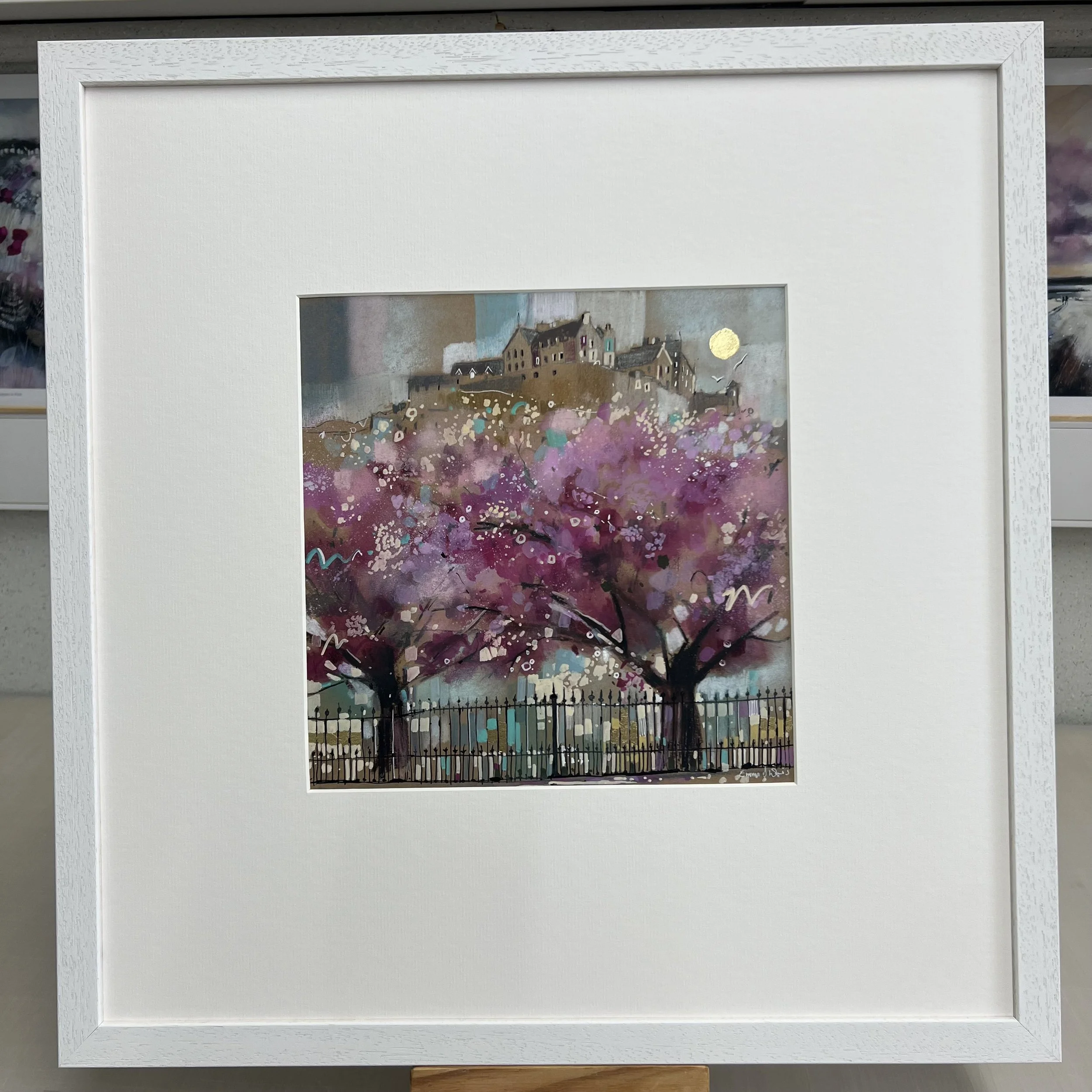 Edinburgh in Bloom by Emma S Davis – original mixed media artwork of Edinburgh Castle overlooking blossom trees in Princes Street Gardens. Framed view.