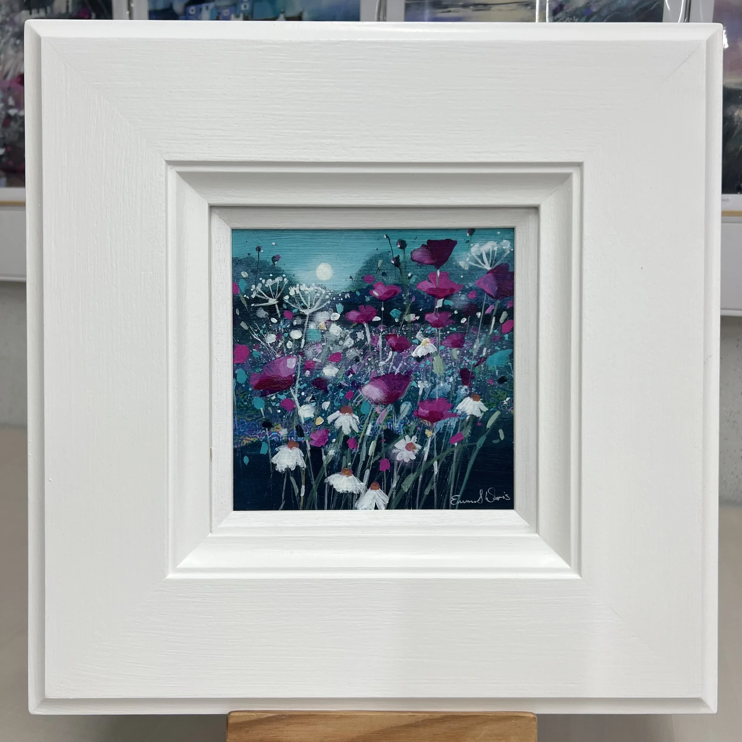 Original oil painting of a Scottish wildflower meadow with rolling hills and blue sky by Scottish artist Emma S Davis. Framed view.