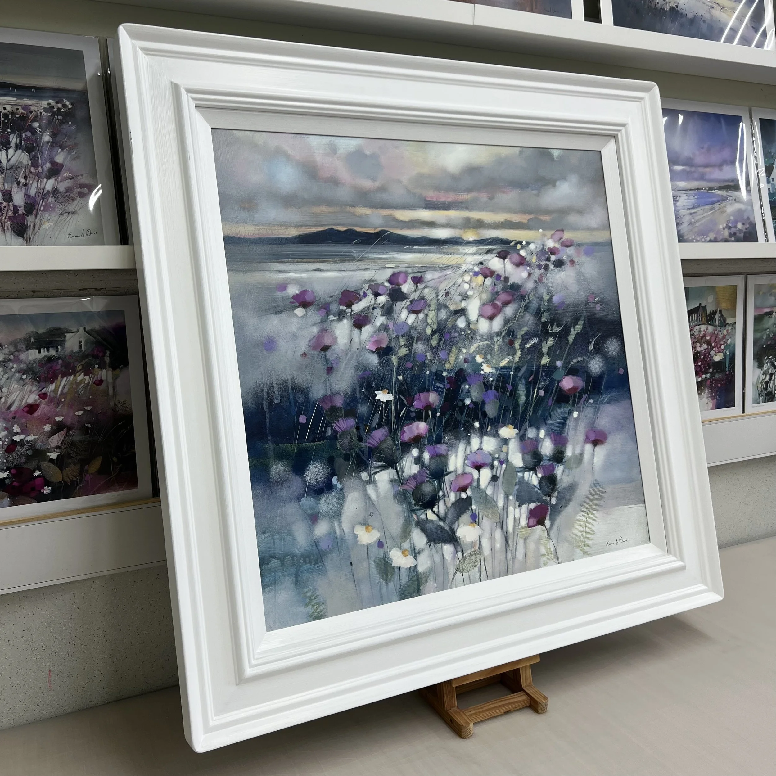 Framed Scottish landscape painting Sunset Thistles and Arran featuring the Isle of Arran and coastal wildflowers. Side view.