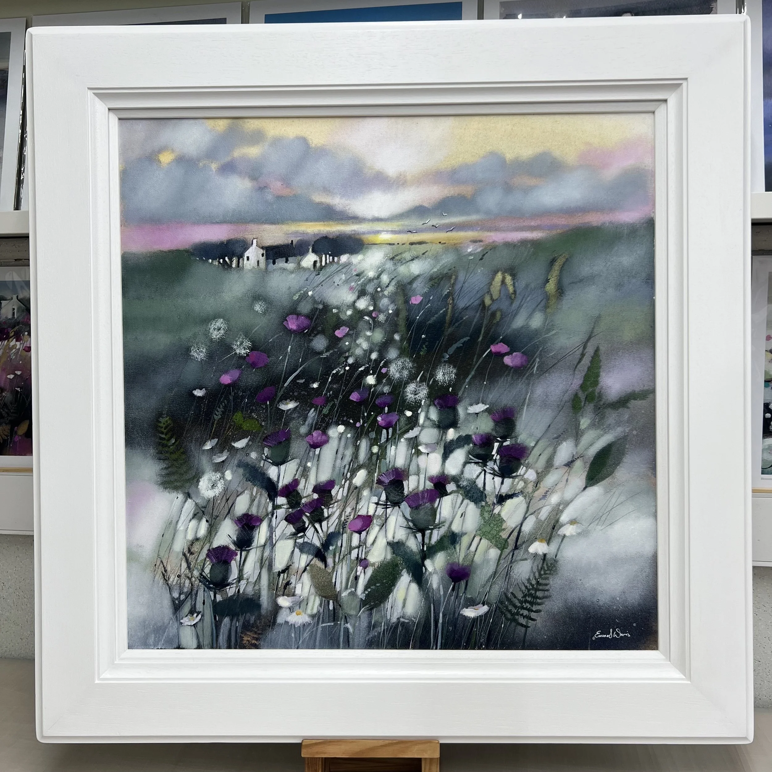 Original oil painting of Scottish thistles and wildflowers surrounding a Highland croft at sunset by Scottish artist Emma S Davis. Framed view.
