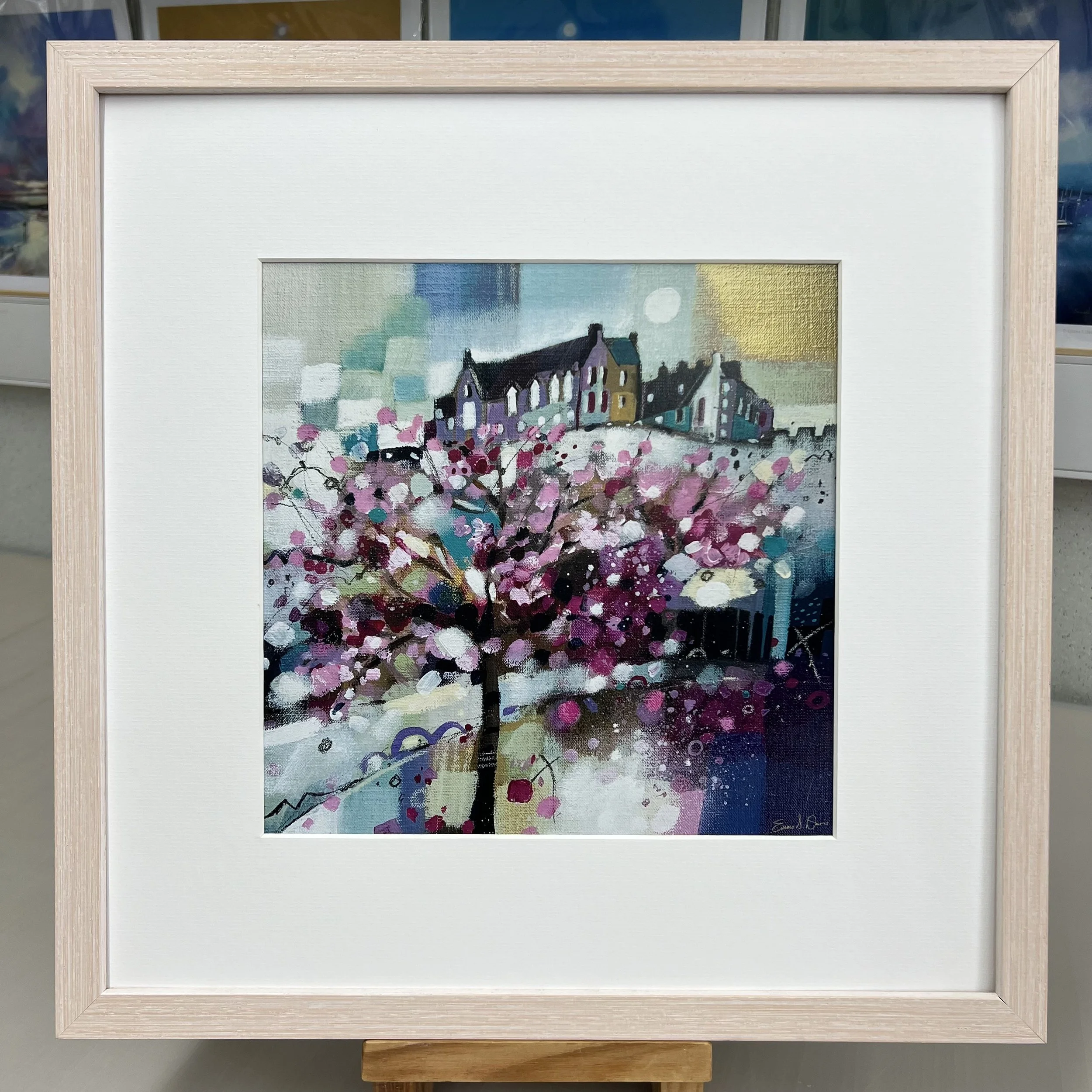 Blossom trees in Princes Street Gardens below Edinburgh Castle come to life in Emma S Davis Artist's open edition art print with limewash frame.