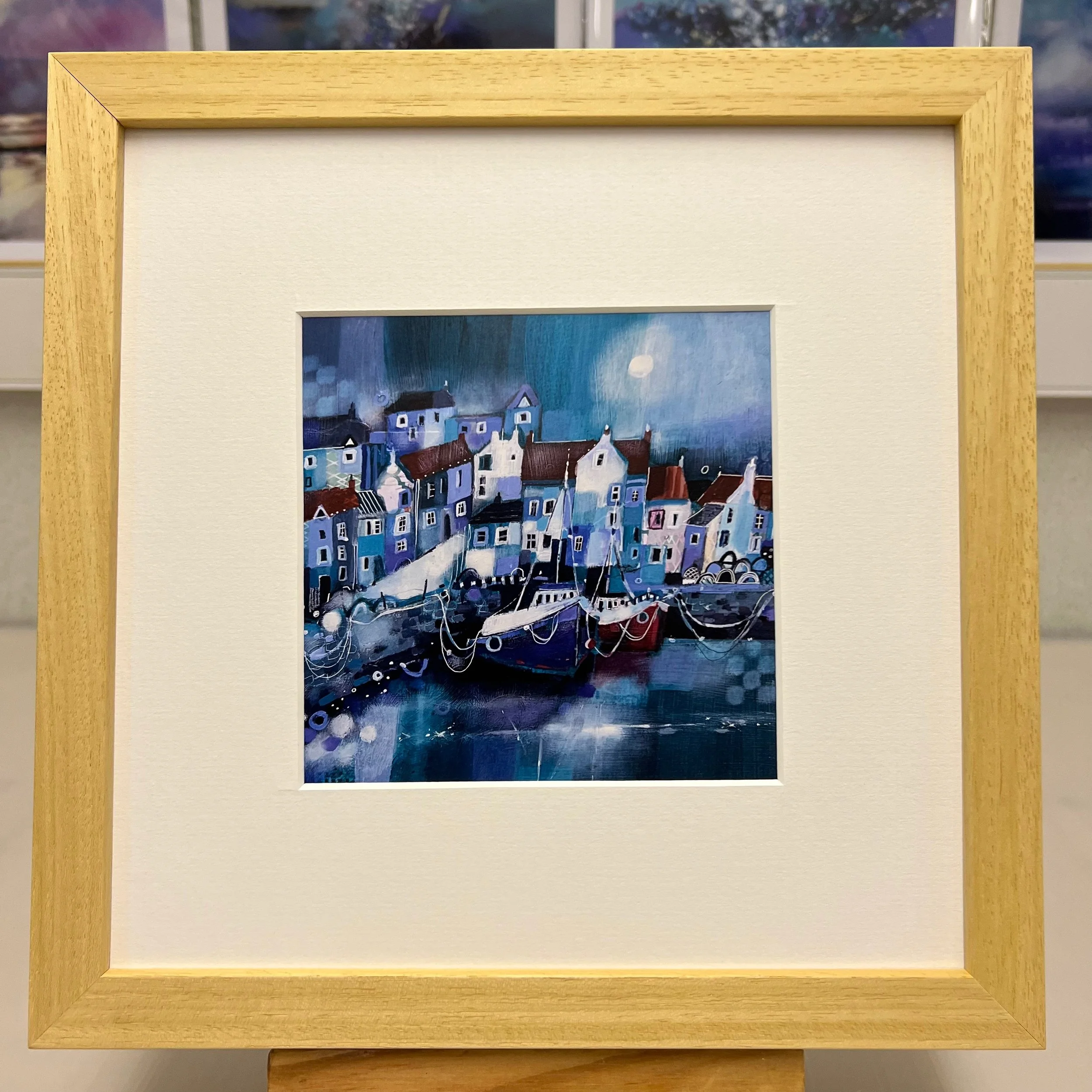 Pittenweem harbour comes to life in Emma S Davis Artist's art greetings card framed in natural