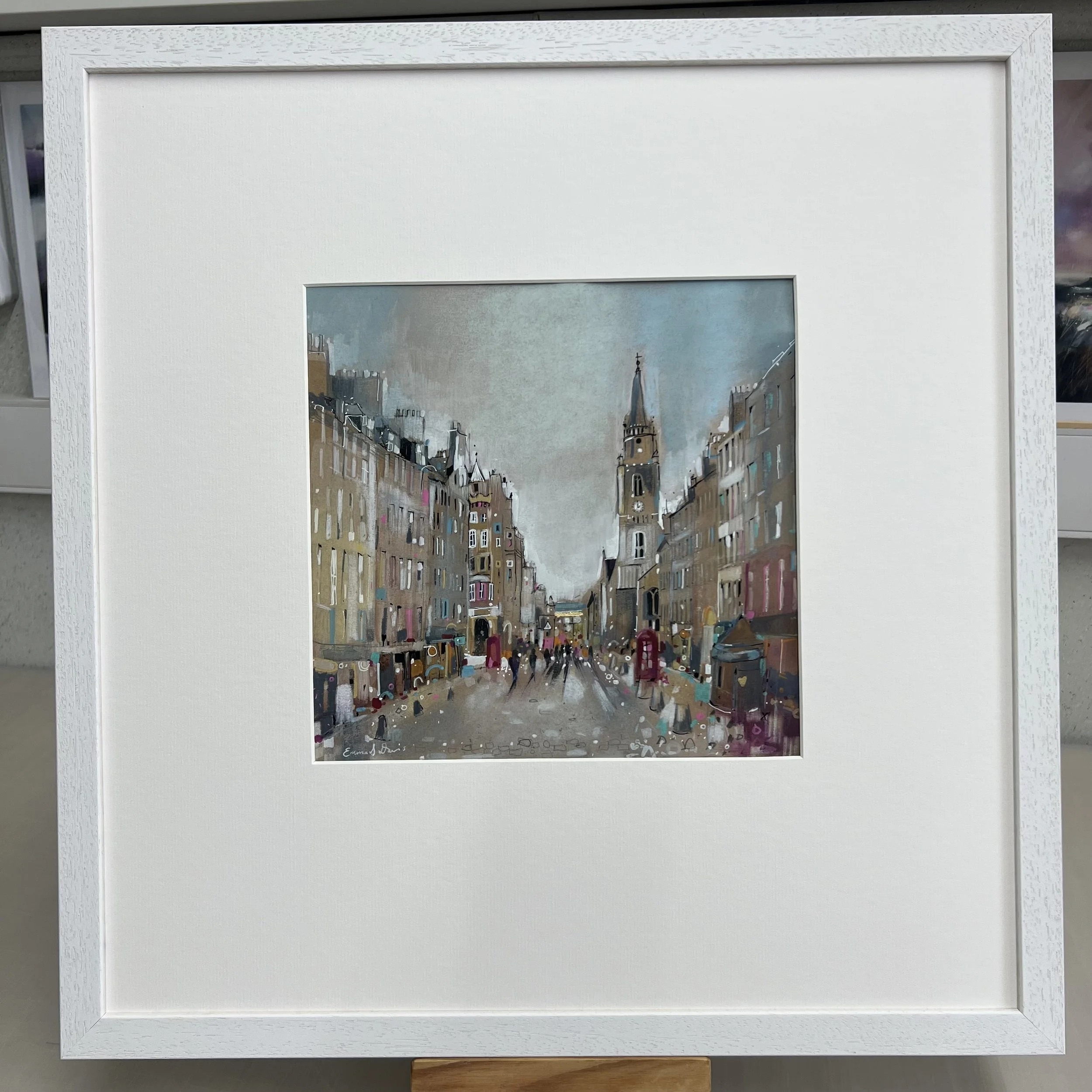 Royal Mile, Edinburgh by Emma S Davis – original mixed media artwork looking along the Royal Mile towards the Tron Kirk. Framed view.
