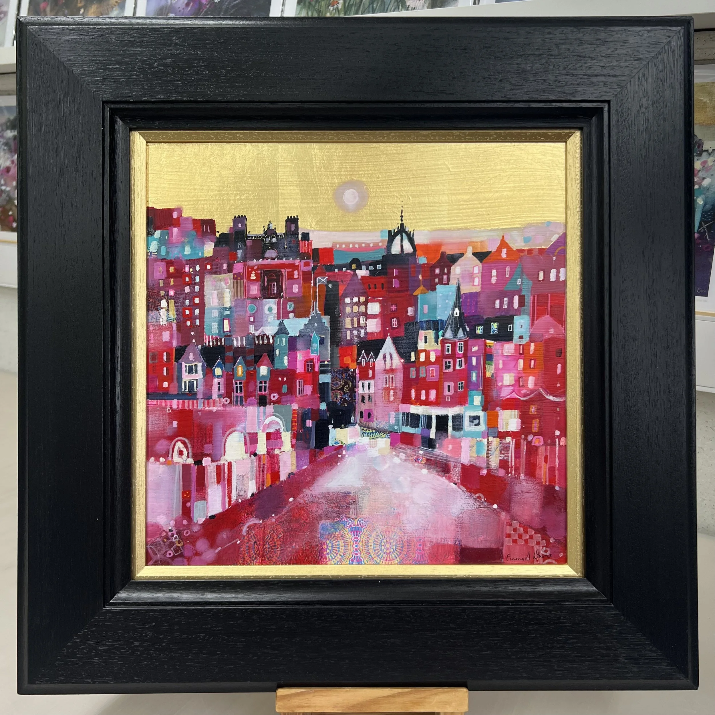 Original oil painting with gold leaf of Edinburgh’s Old Town with colourful buildings, spires and rooftops by Scottish artist Emma S Davis. Framed view.
