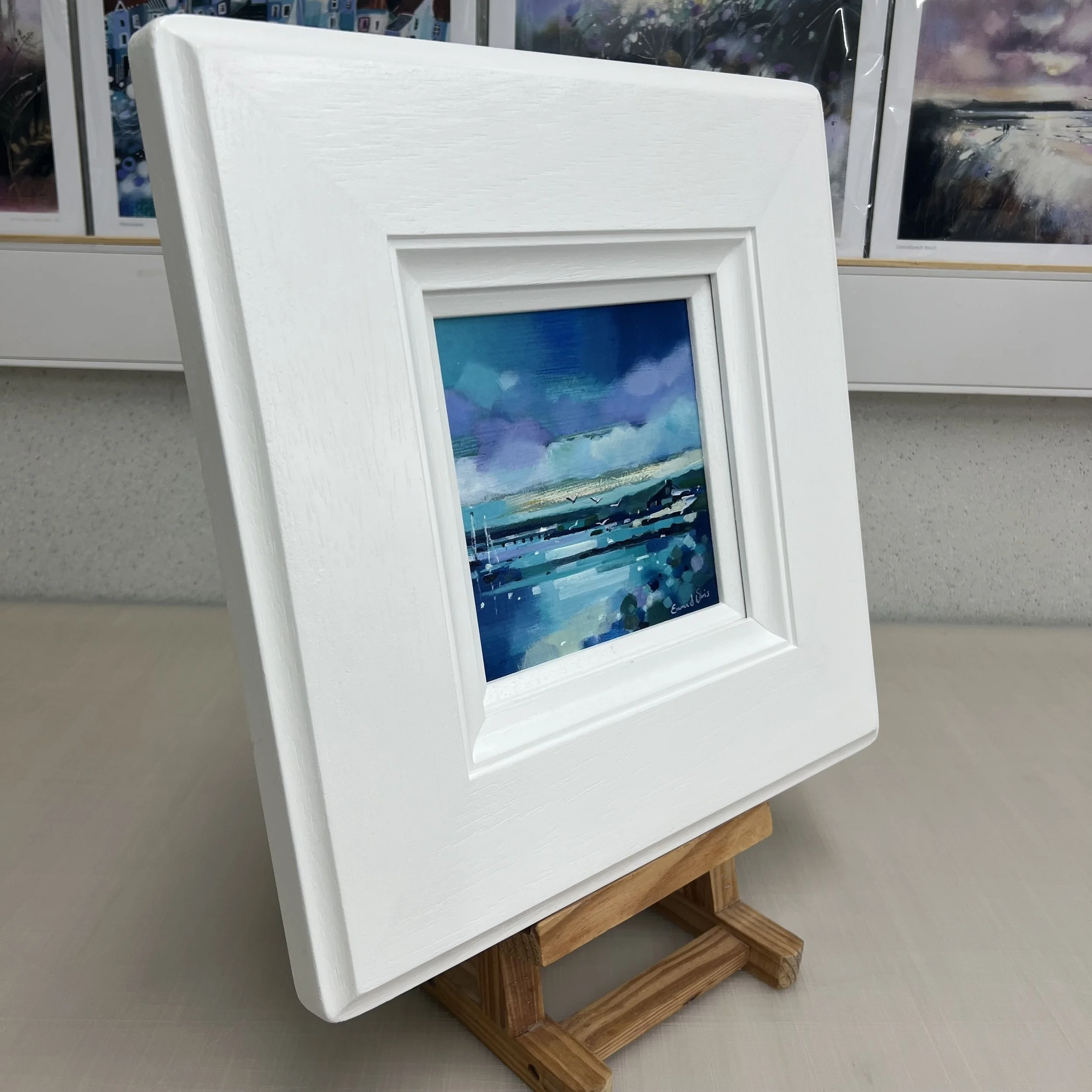 Original oil painting of a white boathouse on the Isle of Gigha surrounded by wildflowers and coastal scenery by Scottish artist Emma S Davis. Side view.