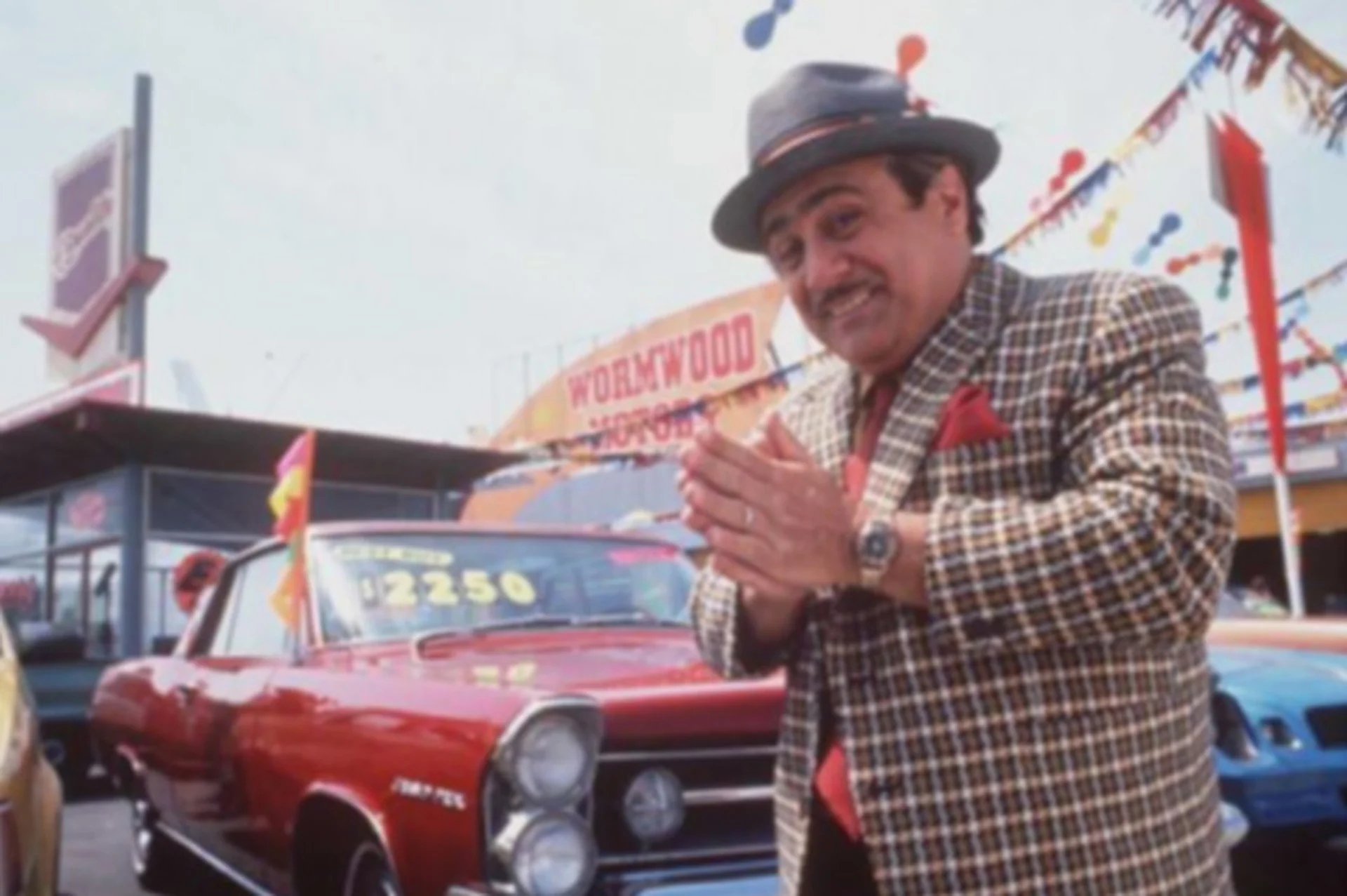 Danny DeVito portraying a used car sales man in Matilda