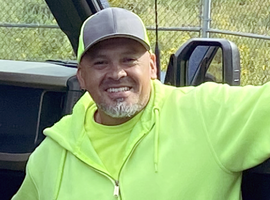 image of Jose Tejeda leaning on the open door of a truck