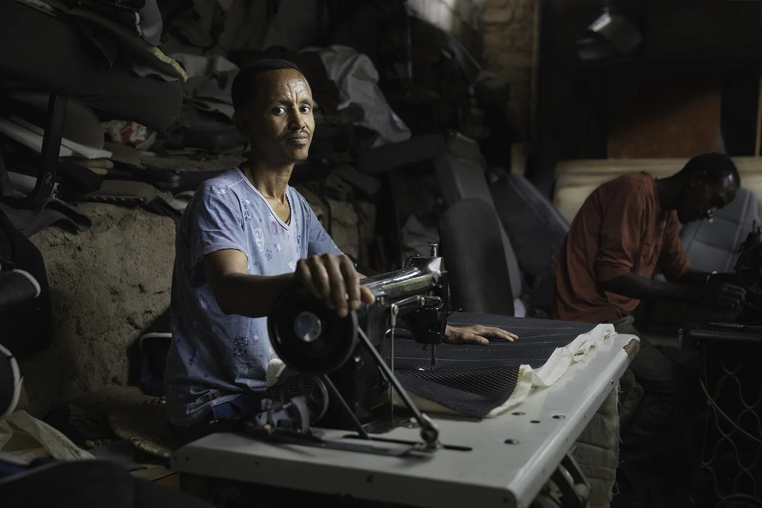 A man works at upholstering car interiors at his shop in Dire Dawa, Ethiopia.
