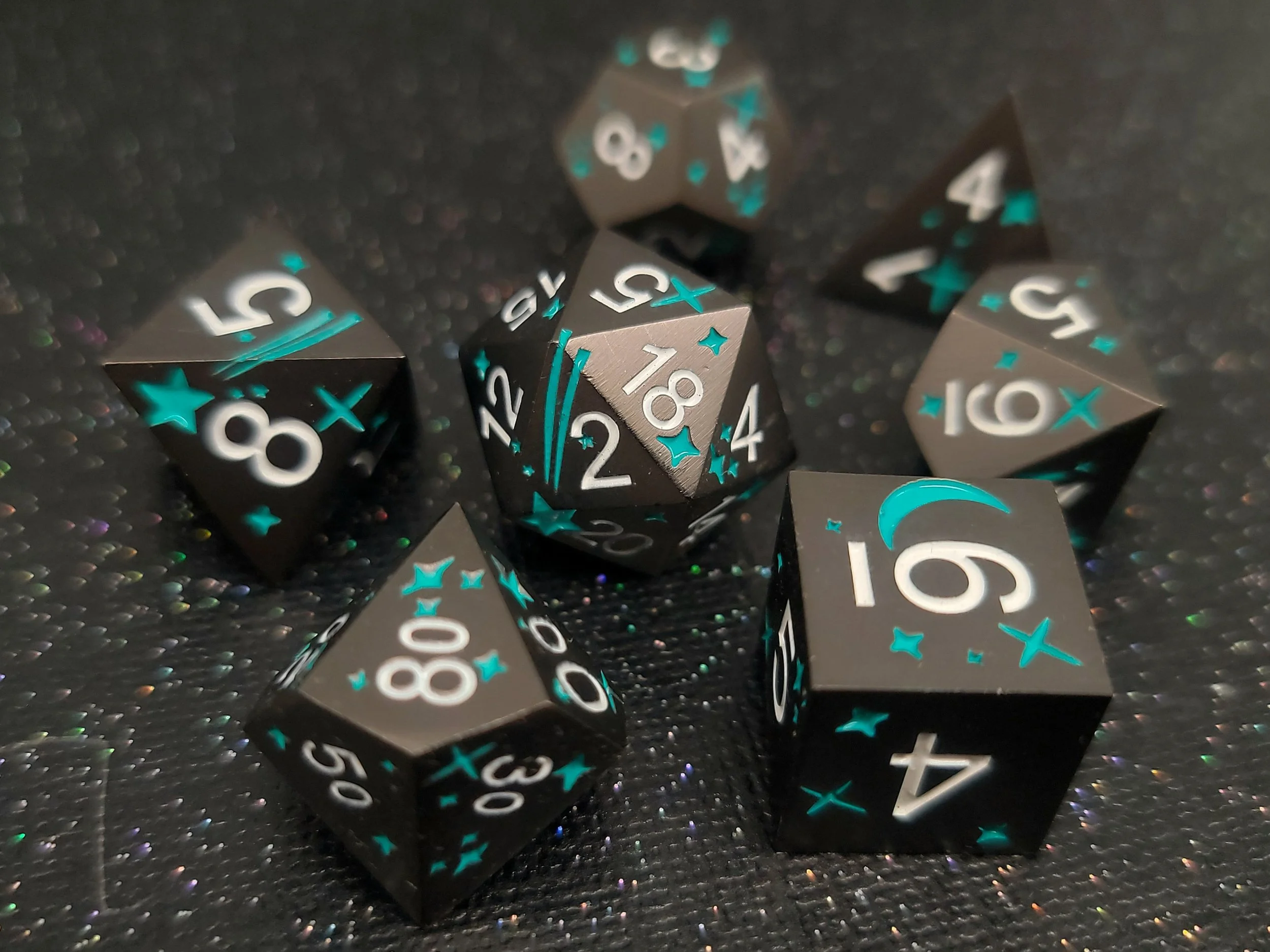 Teal Stars on Black Metal Dice