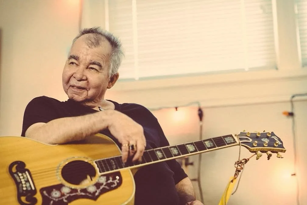 Happy Birthday to the Singing Mailman! We invite everyone whose life has been touched by this man&rsquo;s music to join us at 6pm on the parklet stage. Whether you&rsquo;re joining us on stage or coming to gather with so many who miss John, we&rsquo;