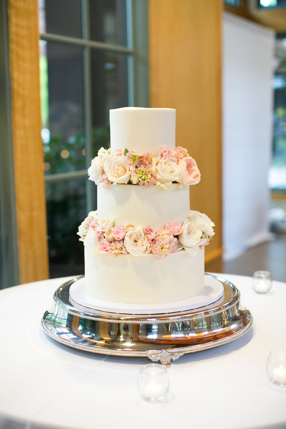 White cake decorated with flowers by Simply Cakes NC