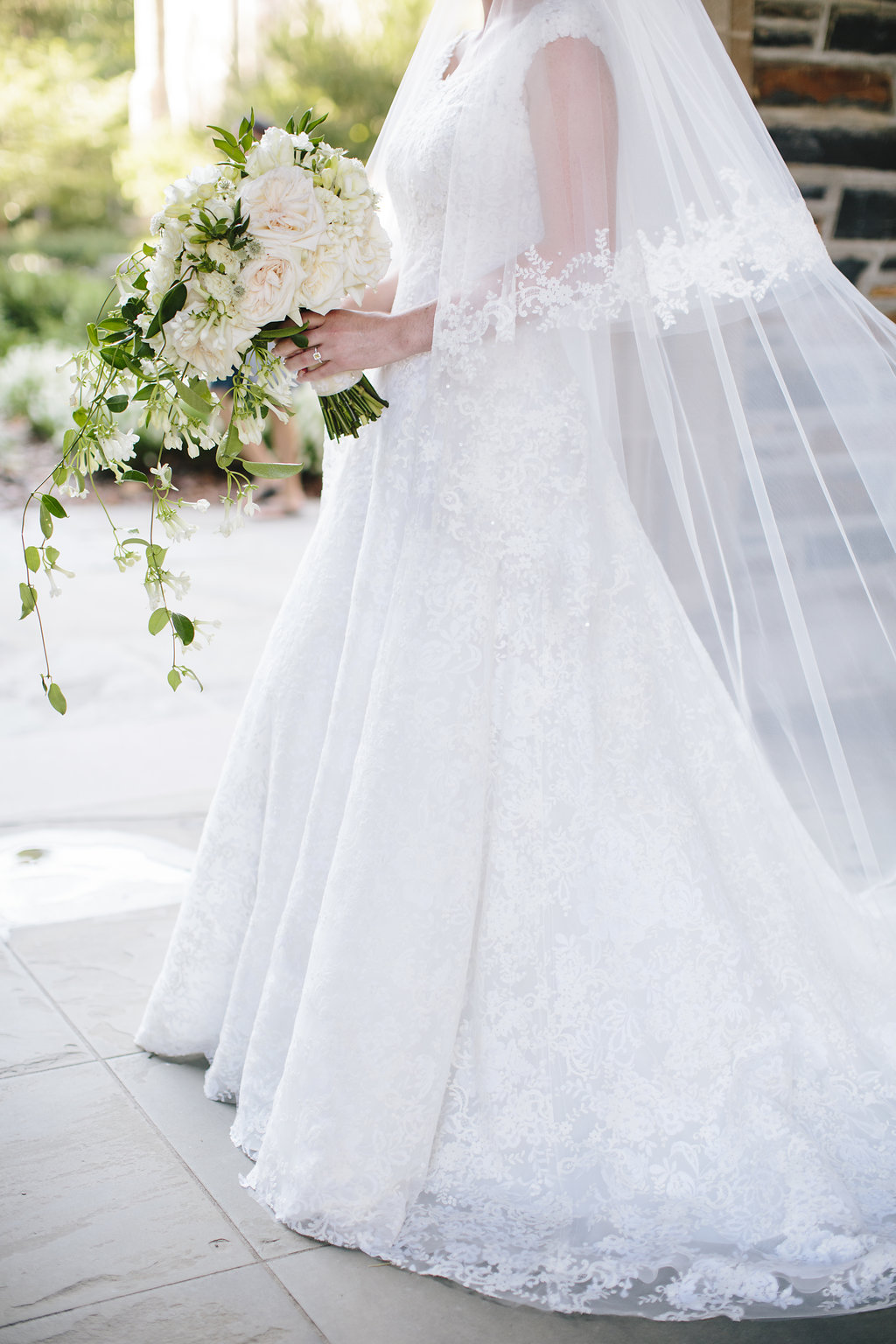 Bride in classic lace wedding gown with veil