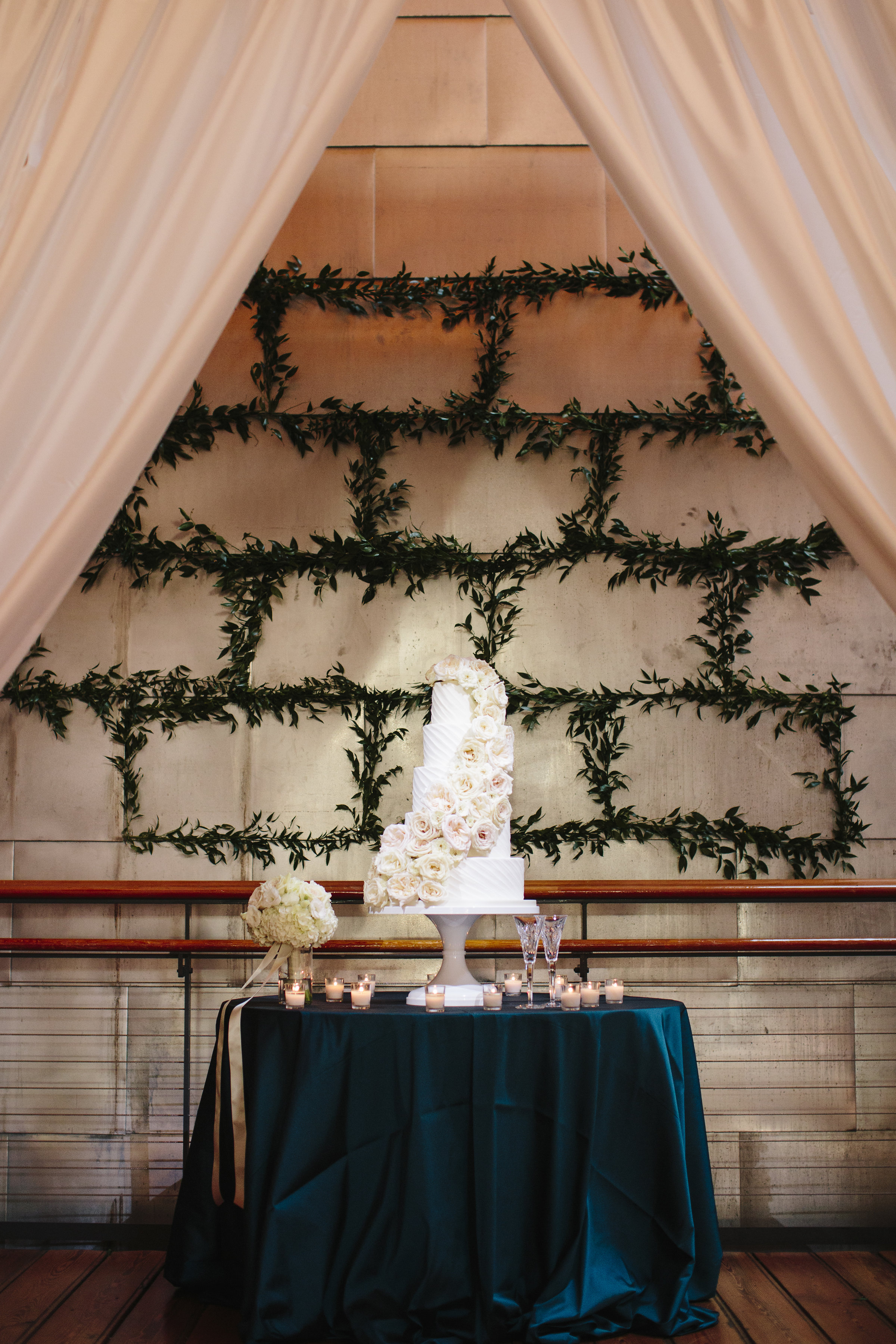 Classic white wedding cake with rose cascade
