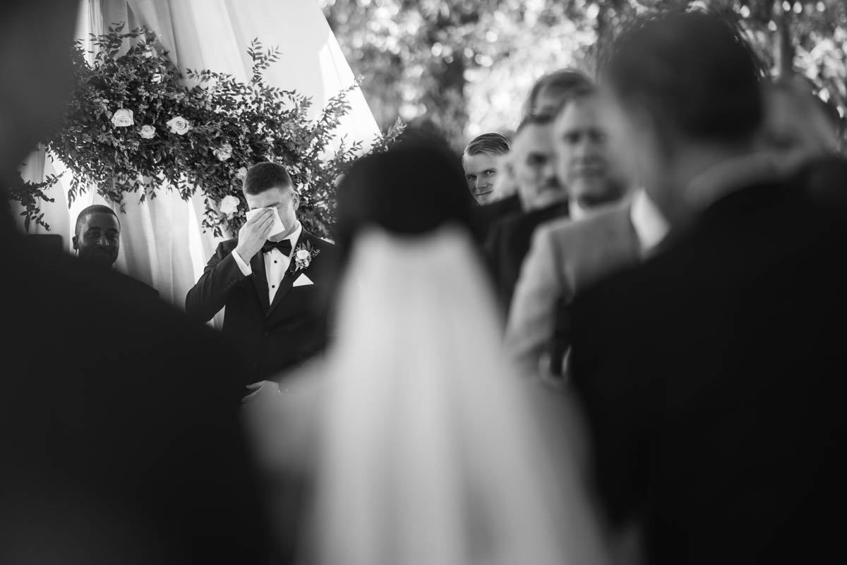 Groom crying as bride walks down the aisle