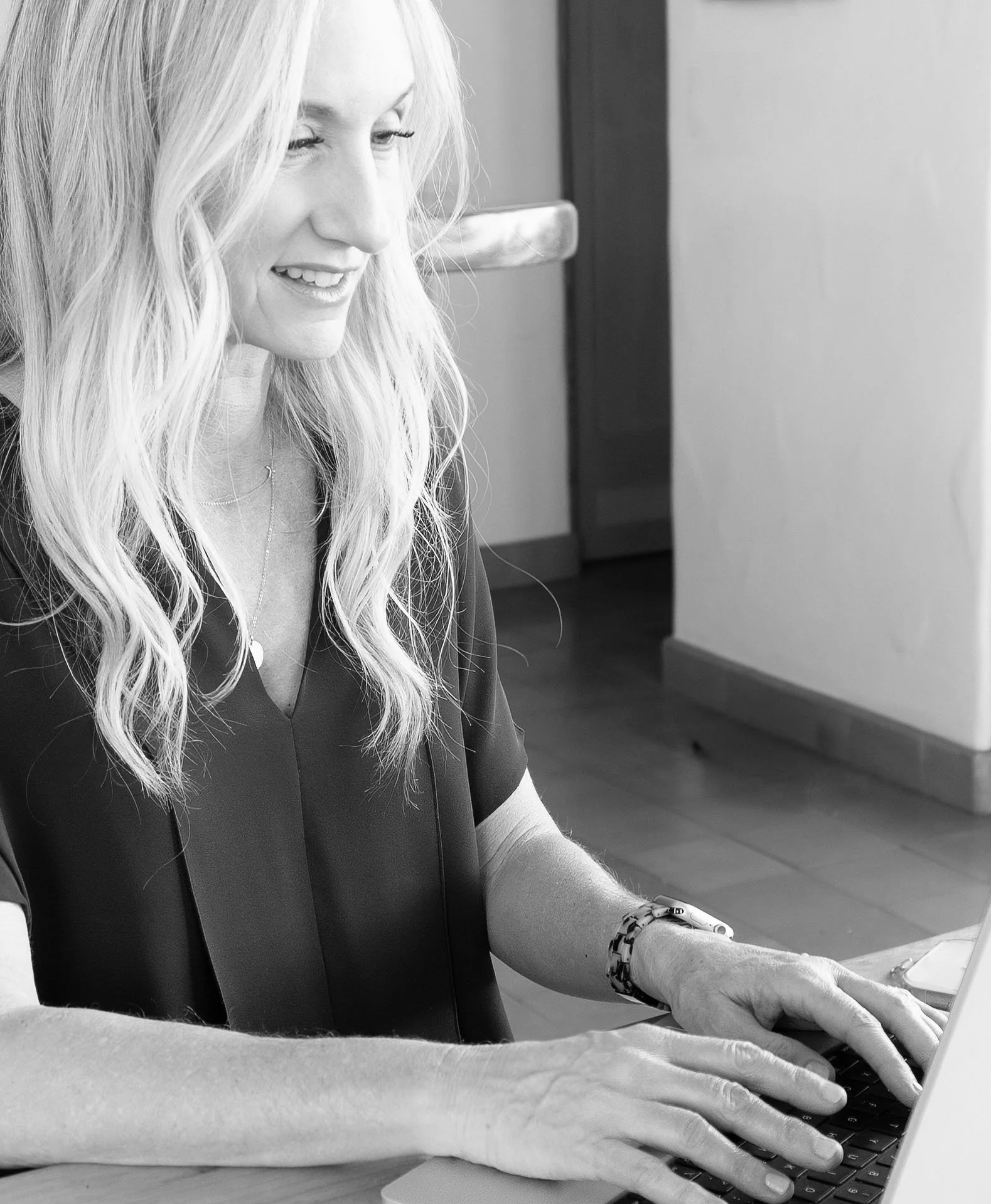 Sharon Newsom working on a laptop