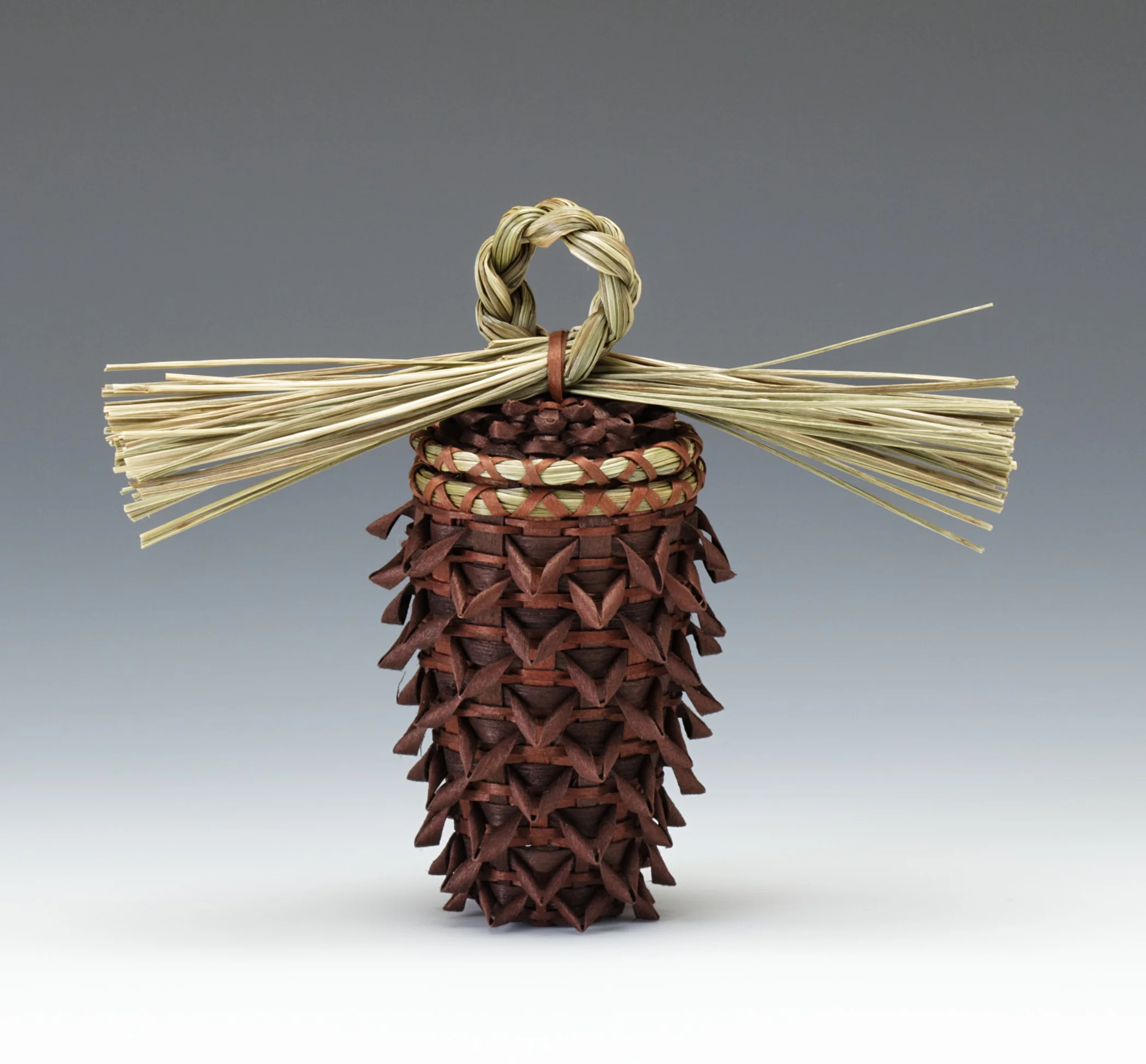 Kim Bryant, American (Penobscot), born 1964, pinecone basket, 2008. Brown ash and sweetgrass; brown dye, 4 1/4 × 1 1/2 in. Hood Museum of Art, Dartmouth College: Purchased through the Hood Museum of Art Acquisitions Fund; 2008.69.