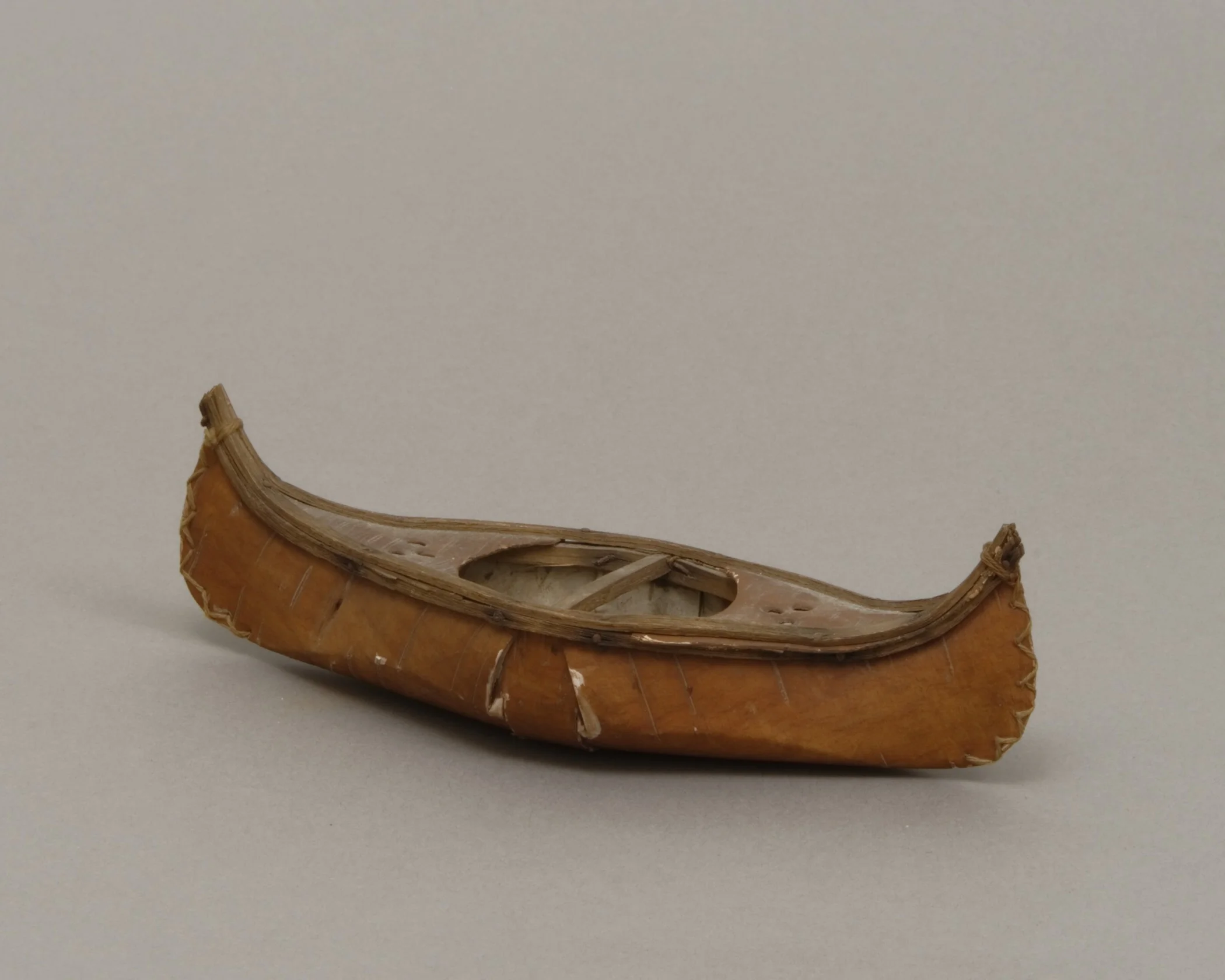 Unknown people (Woodlands), birch bark canoe model, early 20th century. Birch bark and wood, 7 1/2 × 2 7/8 × 2 1/16 in. Hood Museum of Art, Dartmouth College: Gift of Emily W. and George H. Browne; 42.12.8514.