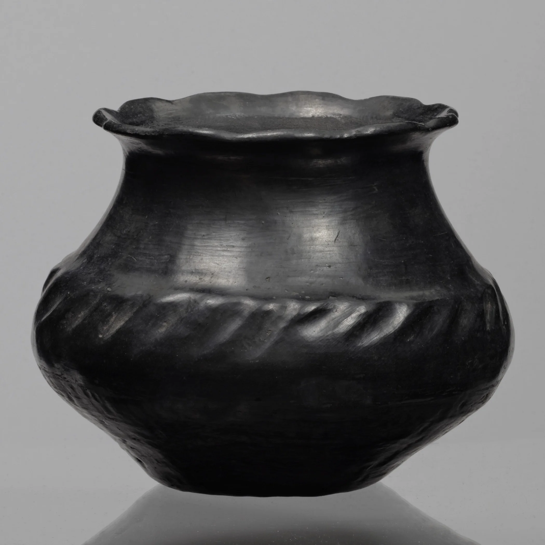 Santa Clara Pueblo (Kha P’o), New Mexico, olla, collected about 1903–7. Blackened terracotta, 6 5/16 × 5 13/16 in. Hood Museum of Art, Dartmouth College: Bequest of Frank C. and Clara G. Churchill; 46.17.10043.