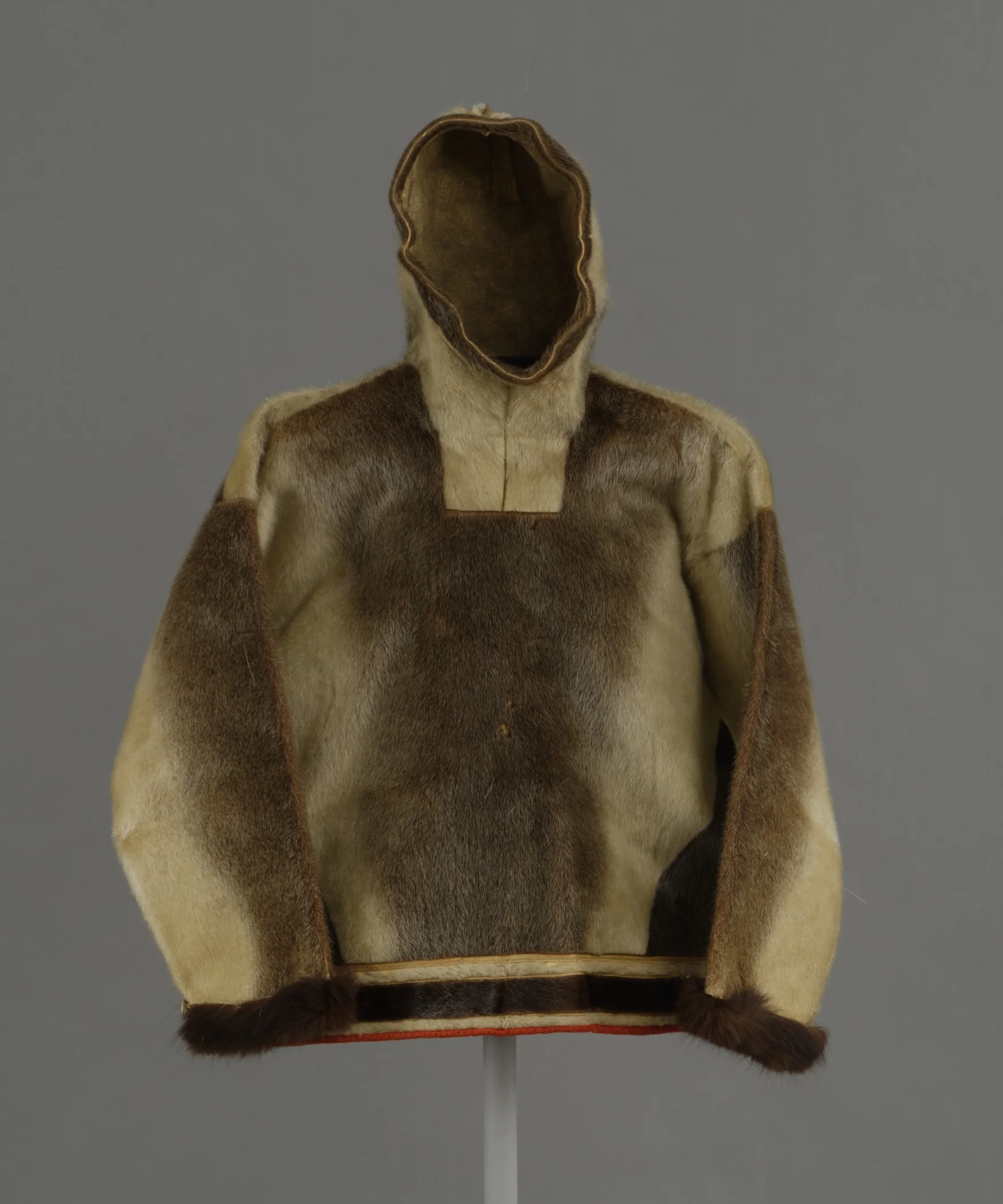 Kalaallit (West Greenlandic Inuit), men’s hooded parka for spring and summer, about 1897. Sealskin, dog fur cuffs, sinew, and cloth, height: 36 1/4 in. Hood Museum of Art, Dartmouth College: Gift of Mrs. William Stickney, Class of 1900W; 164.21.15428.