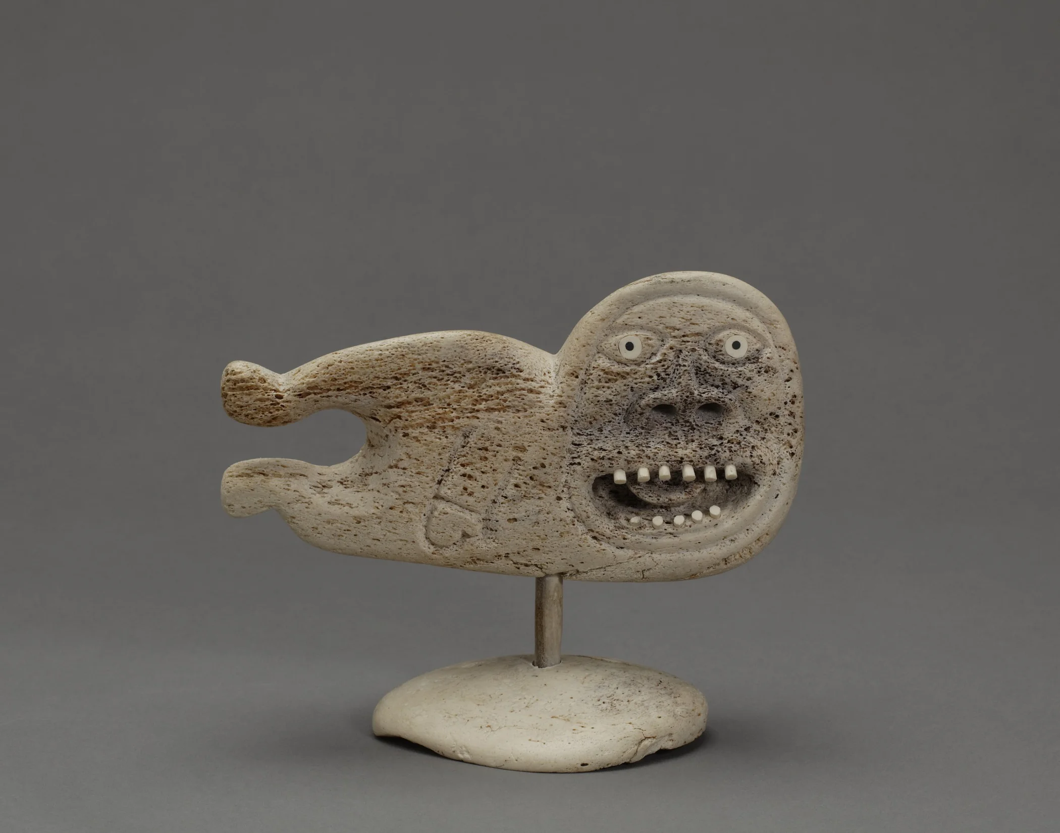 Karoo Ashevak, Canadian (Inuit), 1940–1974, Untitled (Spirit Figure) , about 1970–74. Carved whalebone inlaid with walrus ivory, baleen, and stone, length: approx. 5 in. Hood Museum of Art, Dartmouth College: Bequest of Evelyn Stefansson Nef; 2011.25.1.