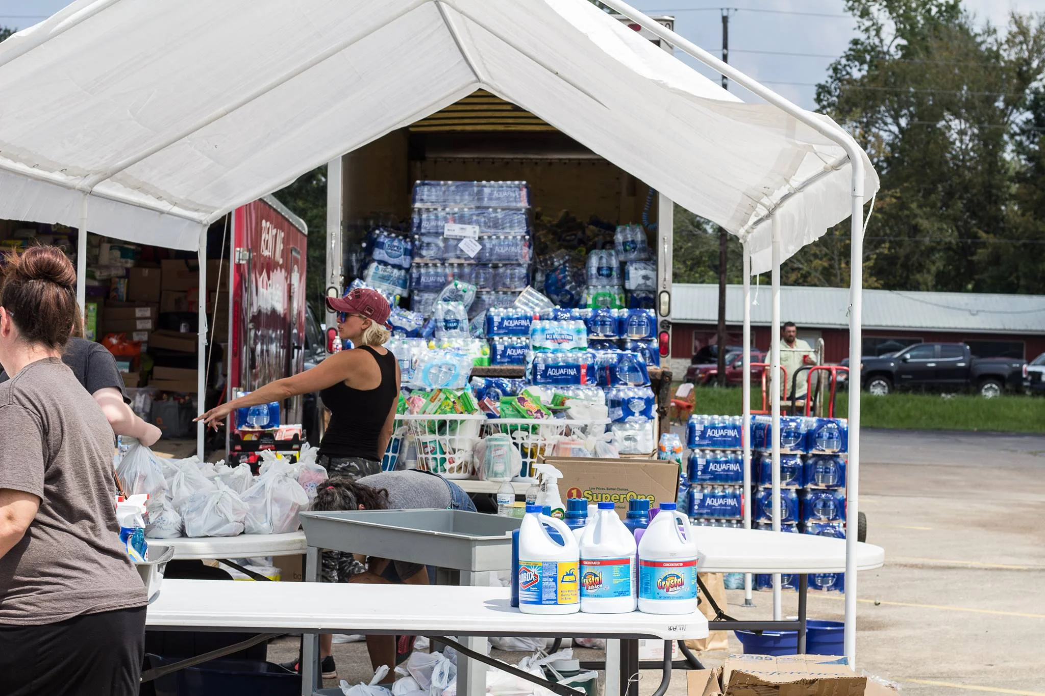 Shylo Eckstrom helps organize efforts to unload trucks that are full of water cases. Photo by Kim Northfield.