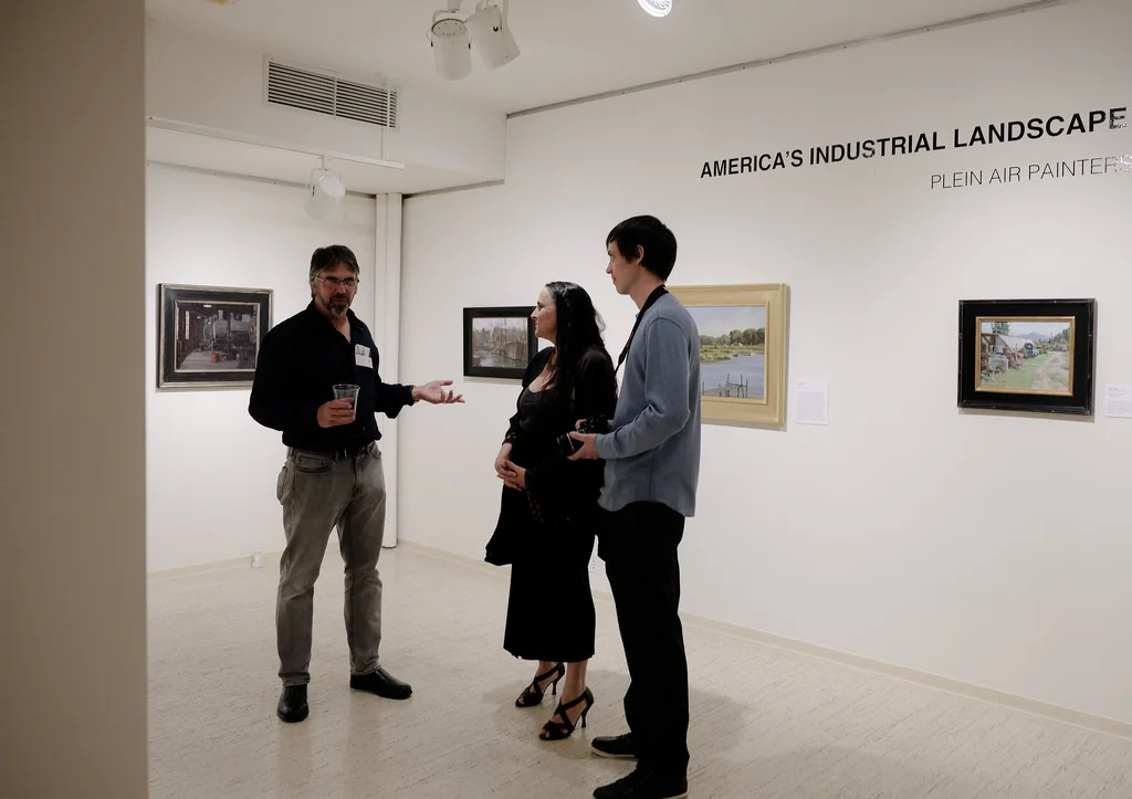 Andy Evansen (left) chats with art enthusiasts at the reception. Photo courtesy of Sharon Mollerus.
