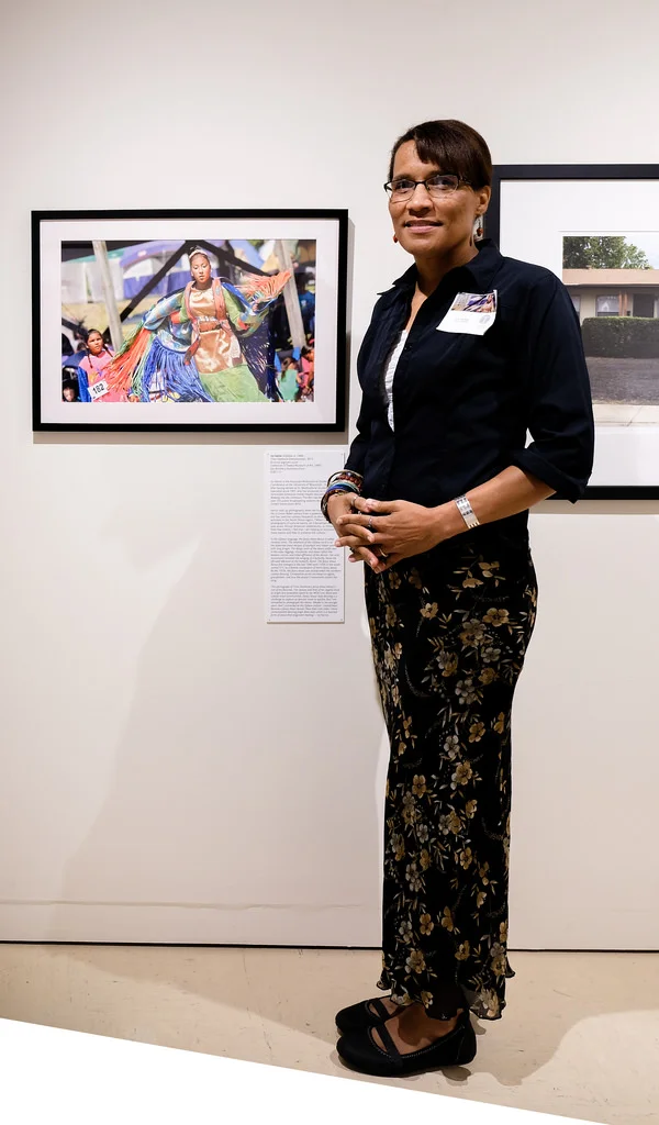 Ivy Vainio next to her “Trina Fasthorse” photograph. Photo courtesy of Sharon Mollerus.