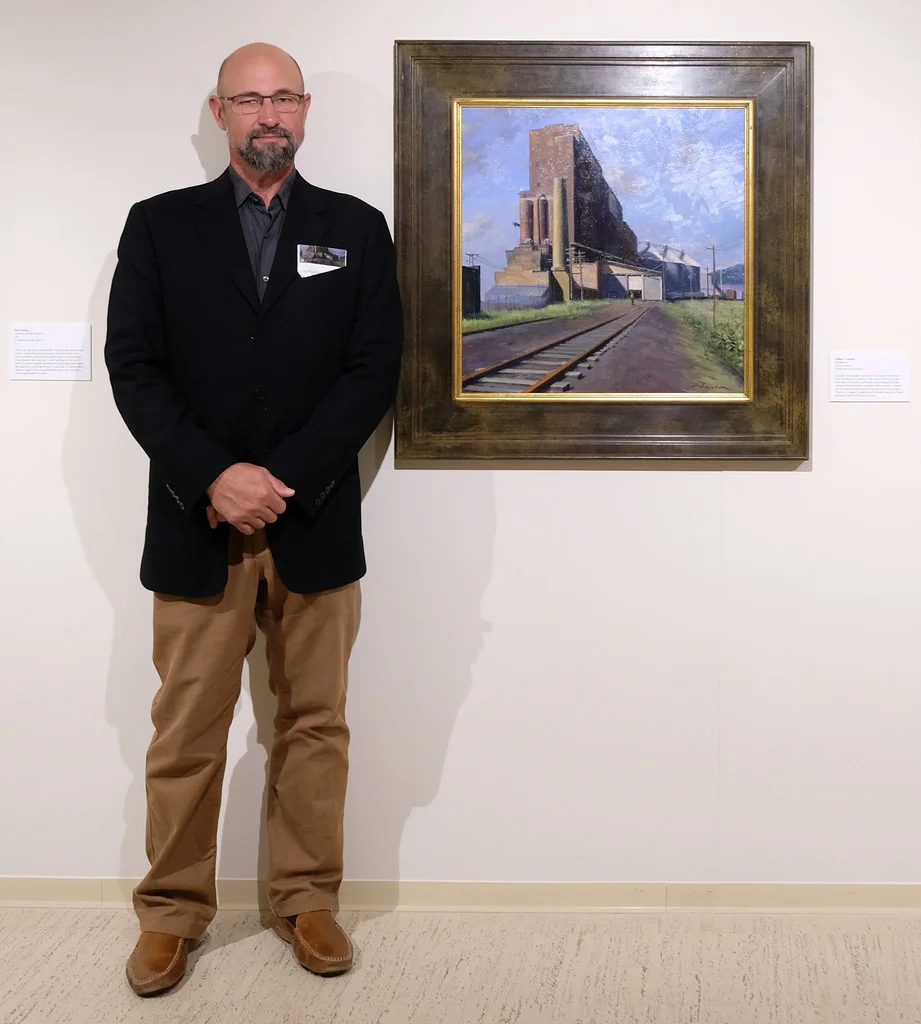 The plaque adjoining Jeffrey T. Larson’s painting reads, "There is a rugged, majestic and honest beauty to these elevators, piers and warehouses." Photo courtesy of Sharon Mollerus.