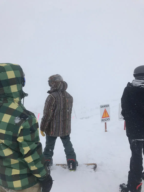 Members of the Ski and Snowboard Club look for direction on the summit of Copper Mountain. Image: Joey Robinson