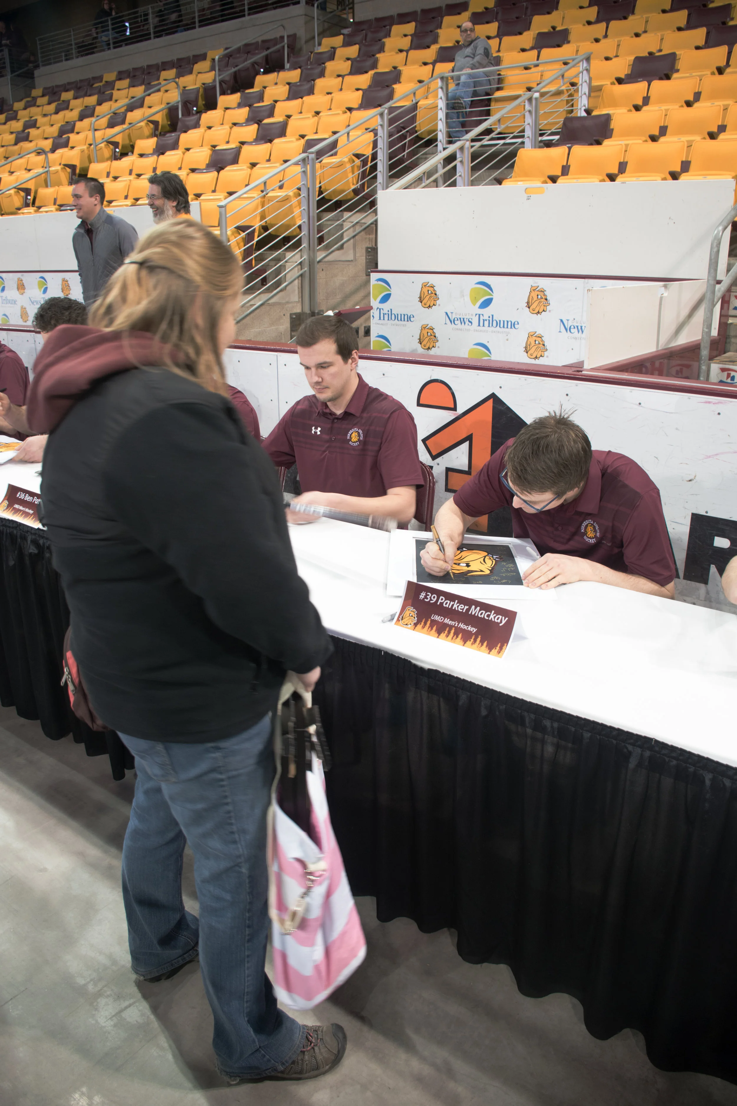 Parker Mackay signs a fan’s poster while signing autographs at Amsoil Arena. Photo by: Connor Shea