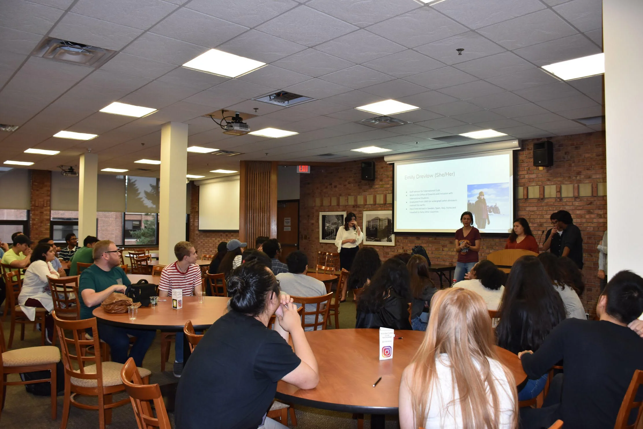 Students listen to International Club Advisor Emily Drevlow at the annual welcome dinner, which took place in Griggs Center. Photo by Trinh Tran