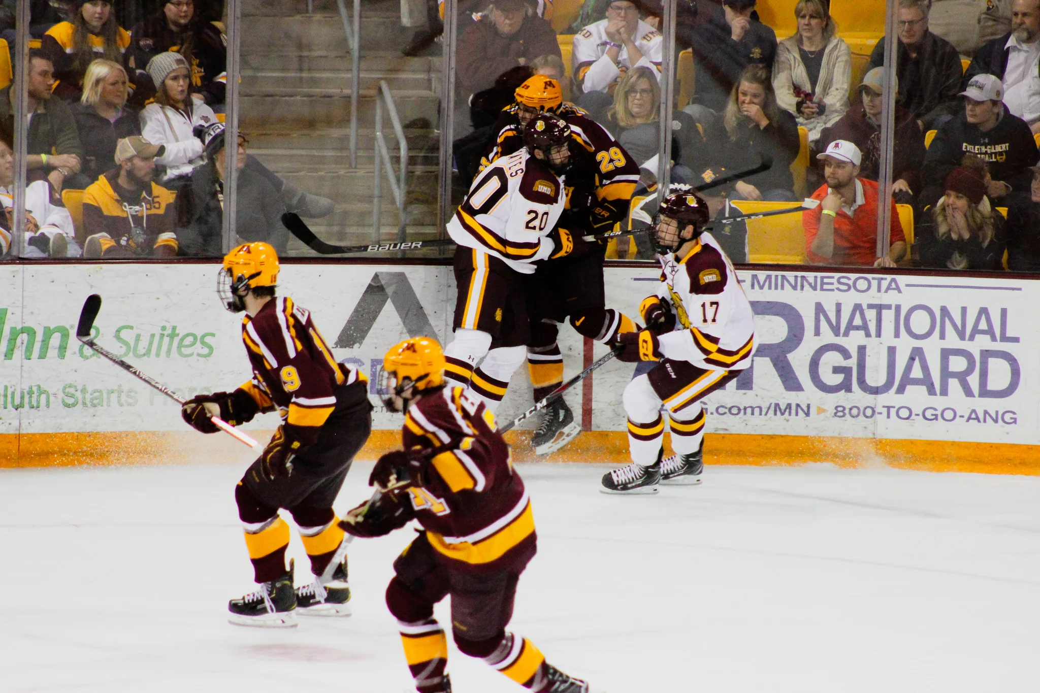 Junior center Jackson Cates (20) pins Minnesota defenseman Tyler Nanne (29) against the boards during Saturdays season opener. Photo by: Morgan Pint.