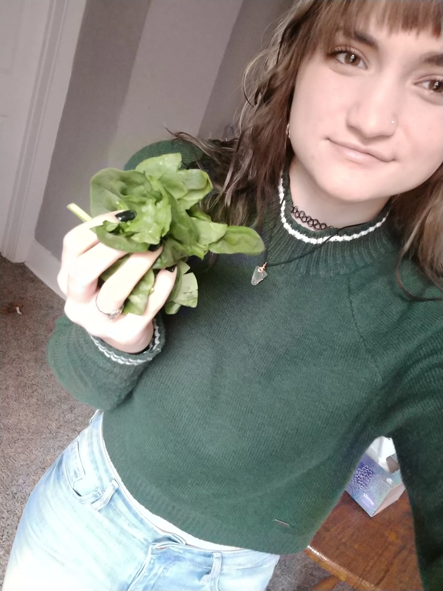 Marissa Stifter, one of the six members of Lettuce Club, with another one of her favorite green vegetables, spinach. Stifter has been helping Andrew Weisz restart the club to help with his stress over it. Photo courtesy of Marissa Stifter