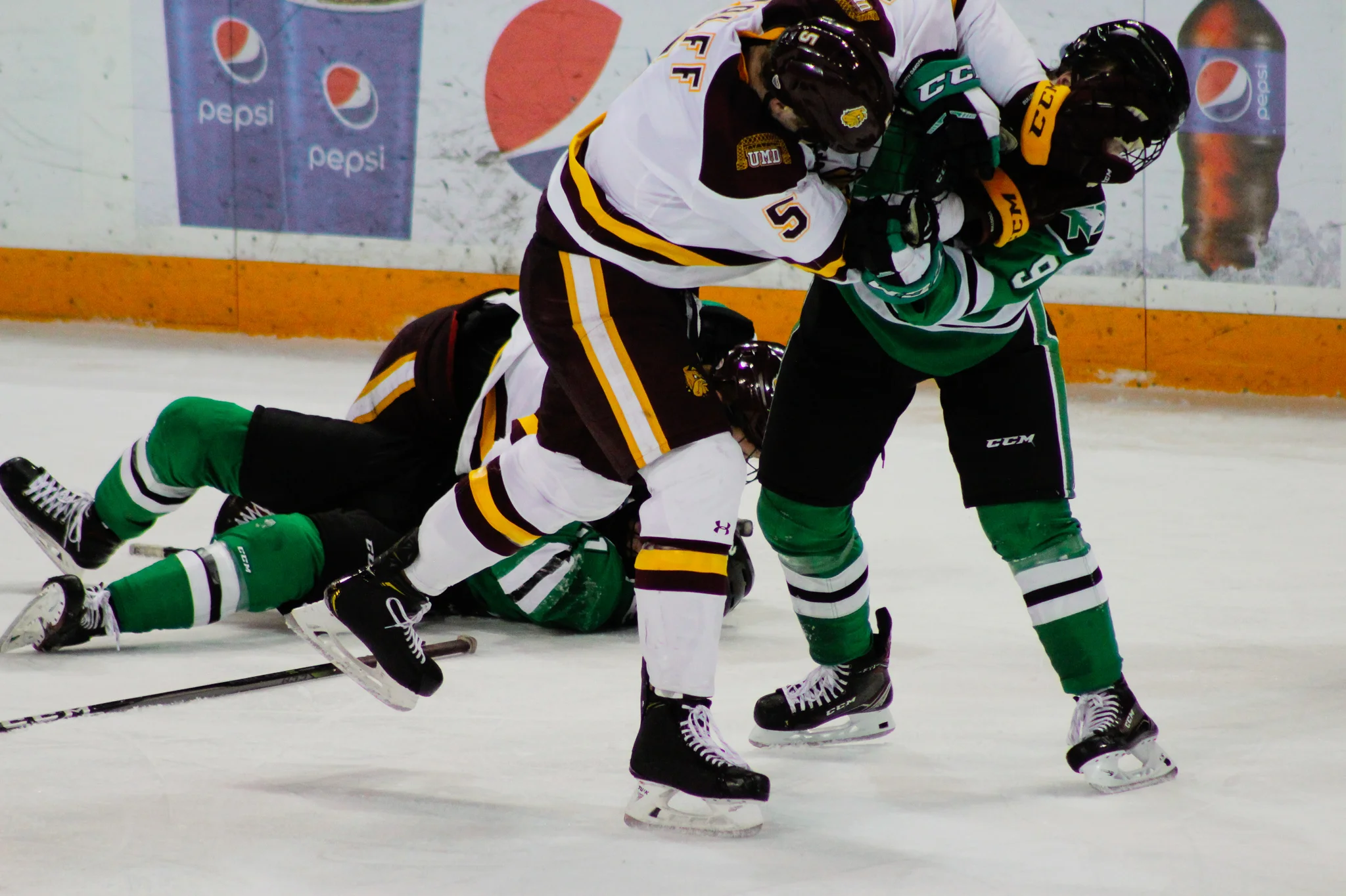 Nick Wolff (5) scuffles with Dixon Bowen (9) in the second period. Photo by: Morgan Pint