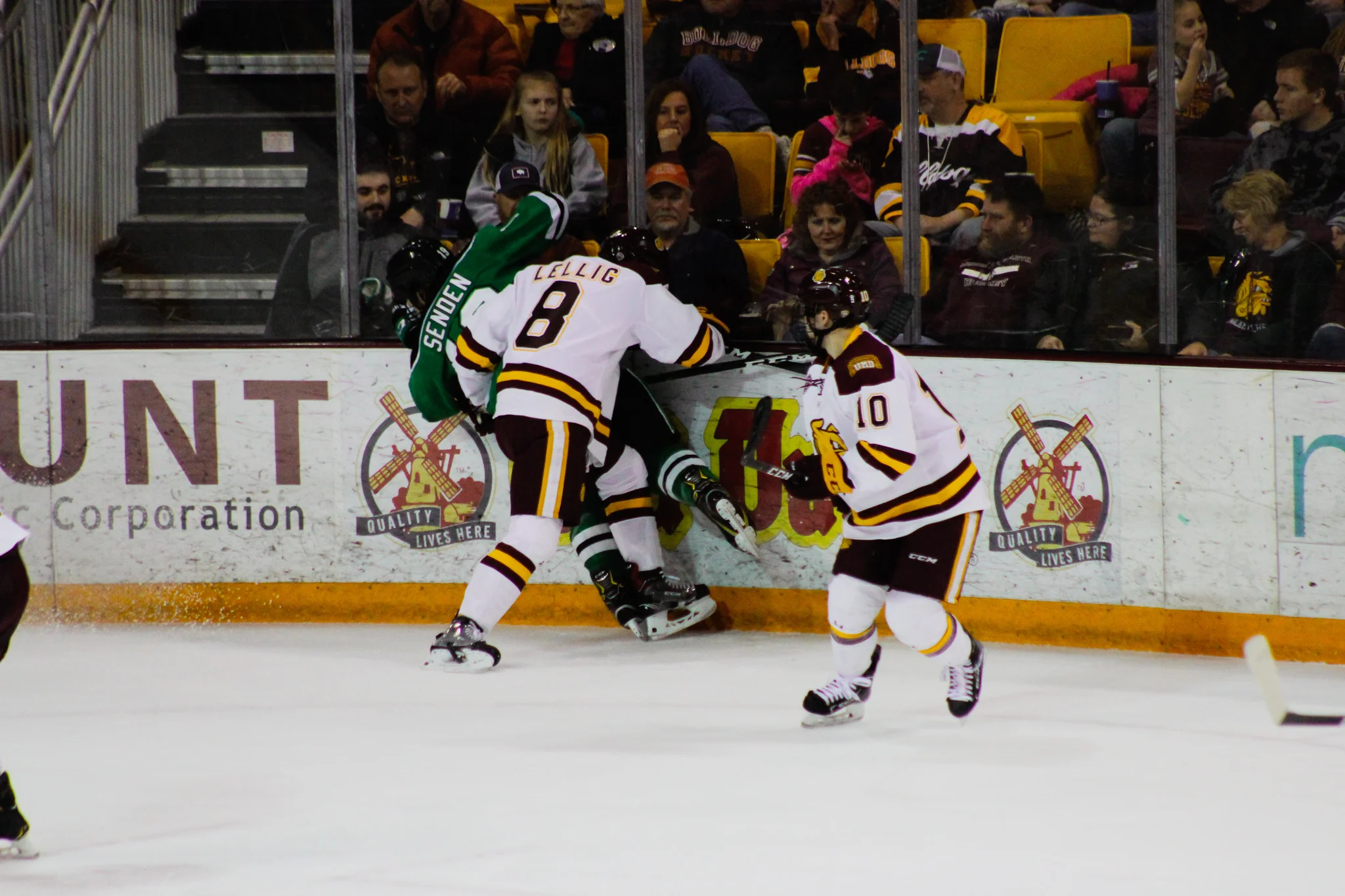 Hunter Lellig (8) checks Mark Senden (19) into the boards. Photo by: Morgan Pint