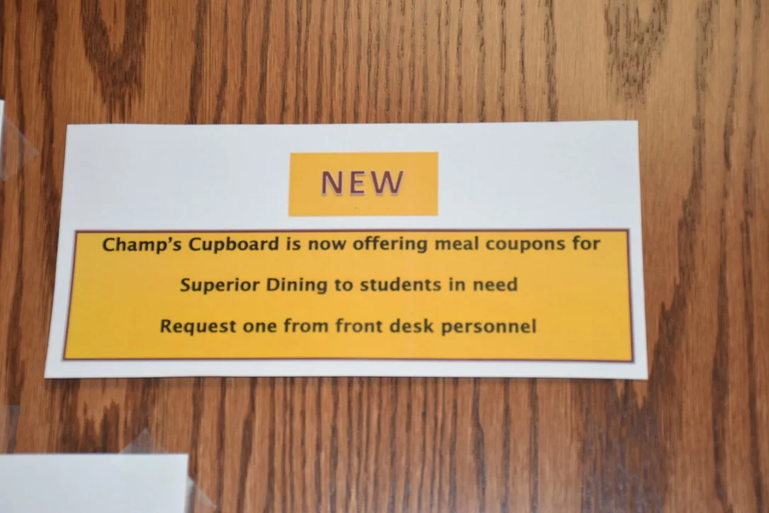 Signage inside the Cupboard indicates the new coupons available to students. Photo by Heidi Stang