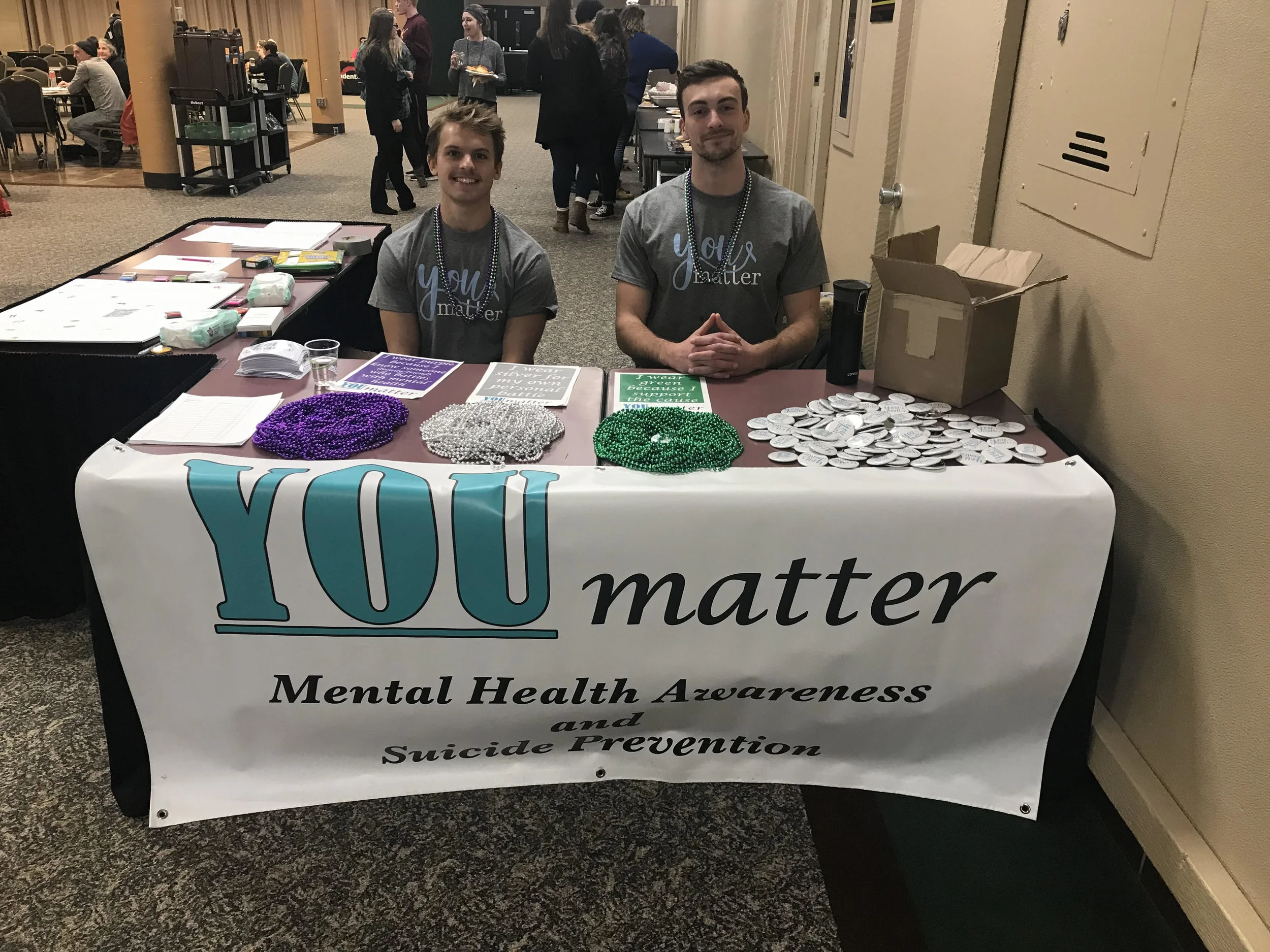 YOUmatter members Jackson Eidsvold (left) and Luke Houska (right) welcome students to a YOUmatter event. Photo courtesy of Kalynn Tilton