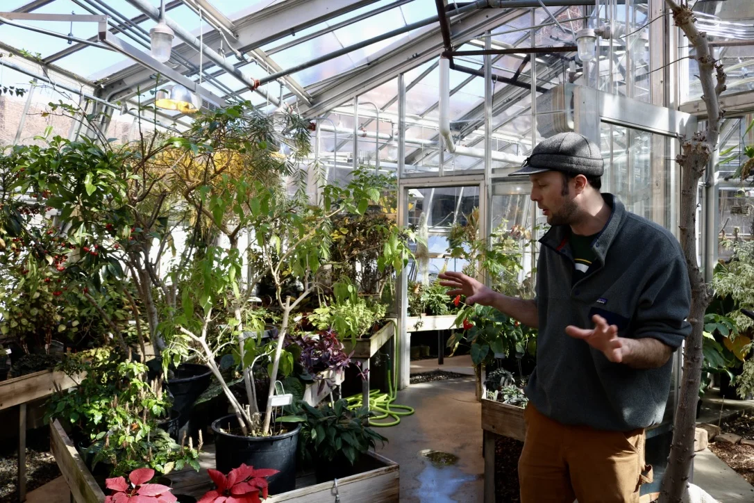 Greenhouse manager Matthew Jahnke explains the layout of the Lower Greenhouse. Photo by Madison Hunter.
