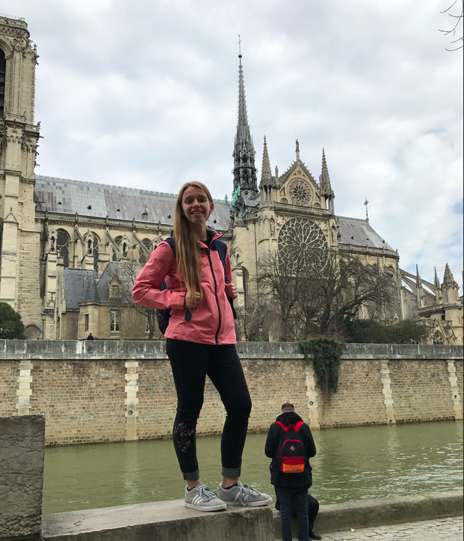 Photo of me with Notre Dame and the large spire in the back