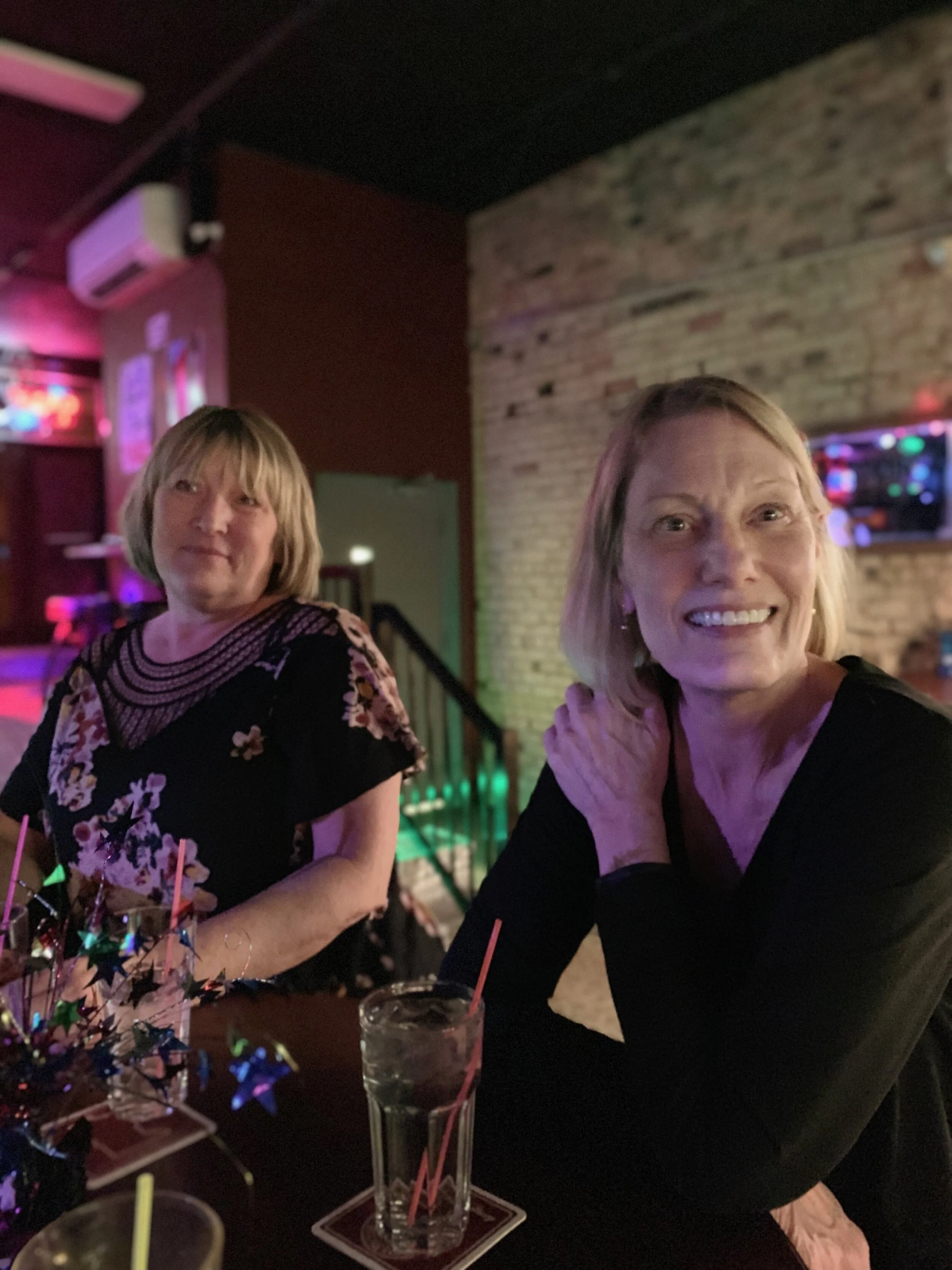 Pat Larson, right — sitting with her sister Armella Bitold, taking a break from swing dancing. Photo courtesy of Tyra Jaramillo.